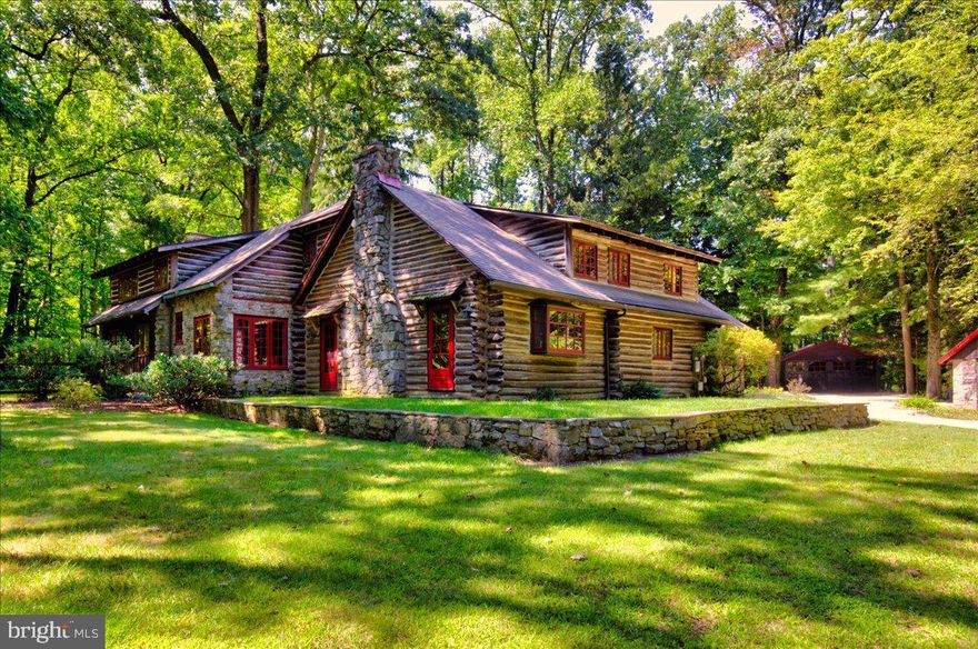 Welcome to your dream home where privacy charm, and character blend seamlessly. Nestled in the serene community of Valley Forge Mountain in Malvern, this exquisite log cabin is set on a sprawling 2.4-acre wooded lot offering the perfect blend of privacy and location. As this gorgeous home comes into view up the long driveway, the beauty and elegance of wood and stone, decked out in bright red will take you back to a simpler time. Once inside, this lovingly maintained cabin radiates rustic charm with its open-concept design and natural features. The great room features soaring ceilings with exposed beams, a two-story stone fireplace and unique details which speak to the quality of the home. Expert craftsmanship is around every corner from the unique colonial locksets to the hand carved staircase, crafted from a tree felled right on the property. Ascend it to the large primary suite that can be your personal retreat at the end of a long day with its vaulted, exposed beam ceiling, hardwood floors and romantic stone fireplace. Imagine relaxing with a good book and a glass of wine by the fire on a cold winter’s night! Two generously sized main level bedrooms and a full bath complete this side of the home. Across the two-story foyer and up the other stairway, there is a lovely overlook to the family room and a quiet nook, the perfect spot for reading. Two additional bedrooms are found on this level, along with another full bath. Back on the main level is a lovely kitchen overlooking the patio and seamlessly flowing to the dining room overlooking the scenic back yard, creating a picturesque dining experience. Adjacent and just around the corner from the kitchen is cozy butler’s pantry with wood stove. Throughout the entire home are the original solid hardwood floors which tie together the rustic elements and overall aesthetic of this charming log home. Step outside to discover this charming home’s exceptional outdoor amenities. A large patio is ideal for al fresco dining or simply enjoying the tranquil surroundings while the gorgeous custom pool promises endless fun and relaxation.  The expansive yard allows for endless fun, gardening, or just getting in touch with nature. A two-car garage and separate shed/workshop space are perfect for projects and storage. Located in the highly sought after Great Valley School District and historic Charlestown Township, this unique home offers the perfect blend of character, privacy, and location. Situated close to I-76, 202 and the Septa station in Paoli, reaching Malvern, West Chester, King of Prussia, or Philadelphia is a breeze.  Plus you are on the edge of Valley Forge Park, with miles of hiking, running, and biking waiting for you. Whether you’re a young family seeking the perfect backdrop for growth and adventure, or simply wanting to enjoy a serene lifestyle, this log home stands ready to welcome you. Available for the first time in over 60 years, it’s marriage of rustic charm, amenities and peaceful setting provides the ideal setting for creating lasting memories. Welcome Home!