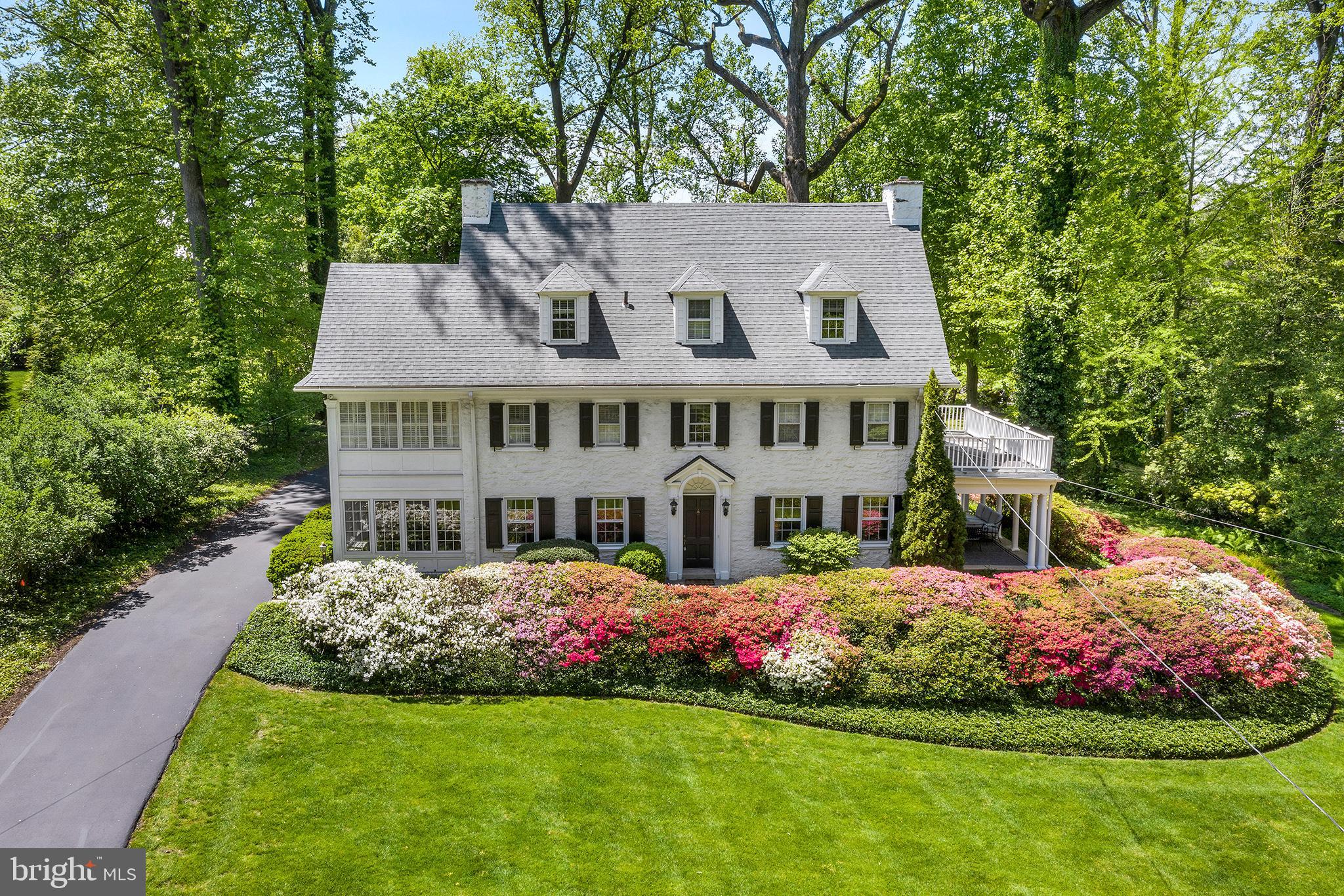 This turn of the century stone colonial is reminiscent of a bygone era and incorporates old world charm with a new vision of youth and vitality. A vibrant Center Hall leads to a fireside Living Room which is enhanced with extensive molding and French Doors leading to a Covered Porch and wrap around Deck perfect for summer entertaining. The formal Dining Room with characteristic frame molding is bounded by an enclosed sun porch/office. A bright, updated kitchen, accented with quartz countertops, cooking island and stainless steel appliances is located at the heart of the home and is central to a Family Room with a gas fireplace, vaulted ceiling, skylights, and a separate Breakfast Room with wet bar and wine cooler. The stairway to the second floor is graced with a landing and large window allowing the sun to stream in through the elegant Center Hall. The Second Floor has a Master Bedroom and attached Bathroom, and access to a sitting/dressing room, with custom built-ins and an abundant amount of natural light. Completing the second floor are 3 additional bedrooms and a hall bath. The Third Floor has 3 additional bedrooms and 1 renovated bathroom providing a private space for Au pair, in-law or guest suite or an additional family entertainment area. The newly finished lower level includes a Powder Room and Laundry and makes for a perfect getaway for teenagers, parents or toddler play. This stately home sits on a one-acre lot surrounded by beautiful mature plantings. Located in the award winning Lower Merion School District, this home offers easy access to the train line, universities, major highways, restaurants, shops and parks. Truly an incredible opportunity to live on one of the most desirable streets and enjoy all the Main Line has to offer.