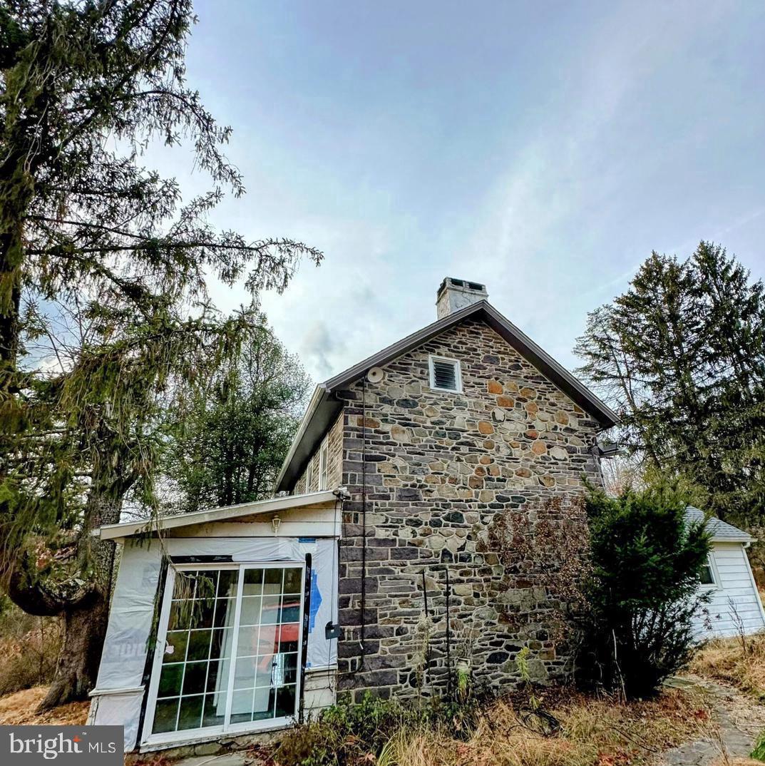 Opportunity awaits with this charming 1-bedroom, 2-bathroom farmhouse, built in 1860, offering a captivating blend of historic elegance and rural tranquility. Nestled on 11.97 picturesque acres, this property provides a peaceful escape surrounded by nature. From the moment you arrive, the timeless character of this farmhouse is evident in its architecture and preserved original details. The expansive grounds offer endless opportunities for gardening, outdoor recreation, or future expansion. Enjoy quiet afternoons on the porch or stroll through the serene landscape, all while taking in the beauty of the surrounding countryside. Adding to the property’s versatility, a separate cottage offers incredible potential for restoration and added value. A spacious pole barn with water and electricity is ideal for storage, hobbies, or car enthusiasts, enhancing the property’s functionality. Located directly across from Nockamixon State Park, you’ll have convenient access to hiking trails, boating, and scenic views, with boat access to Nockamixon Lake just minutes away. This property also benefits from Act 319, a clean and green preferential tax assessment program that provides significantly reduced taxes. Whether you’re drawn to the history, the acreage, or the potential to create a countryside retreat, this unique property invites you to bring your vision to life. Don’t miss the chance to own a piece of history surrounded by nature and endless possibilities.