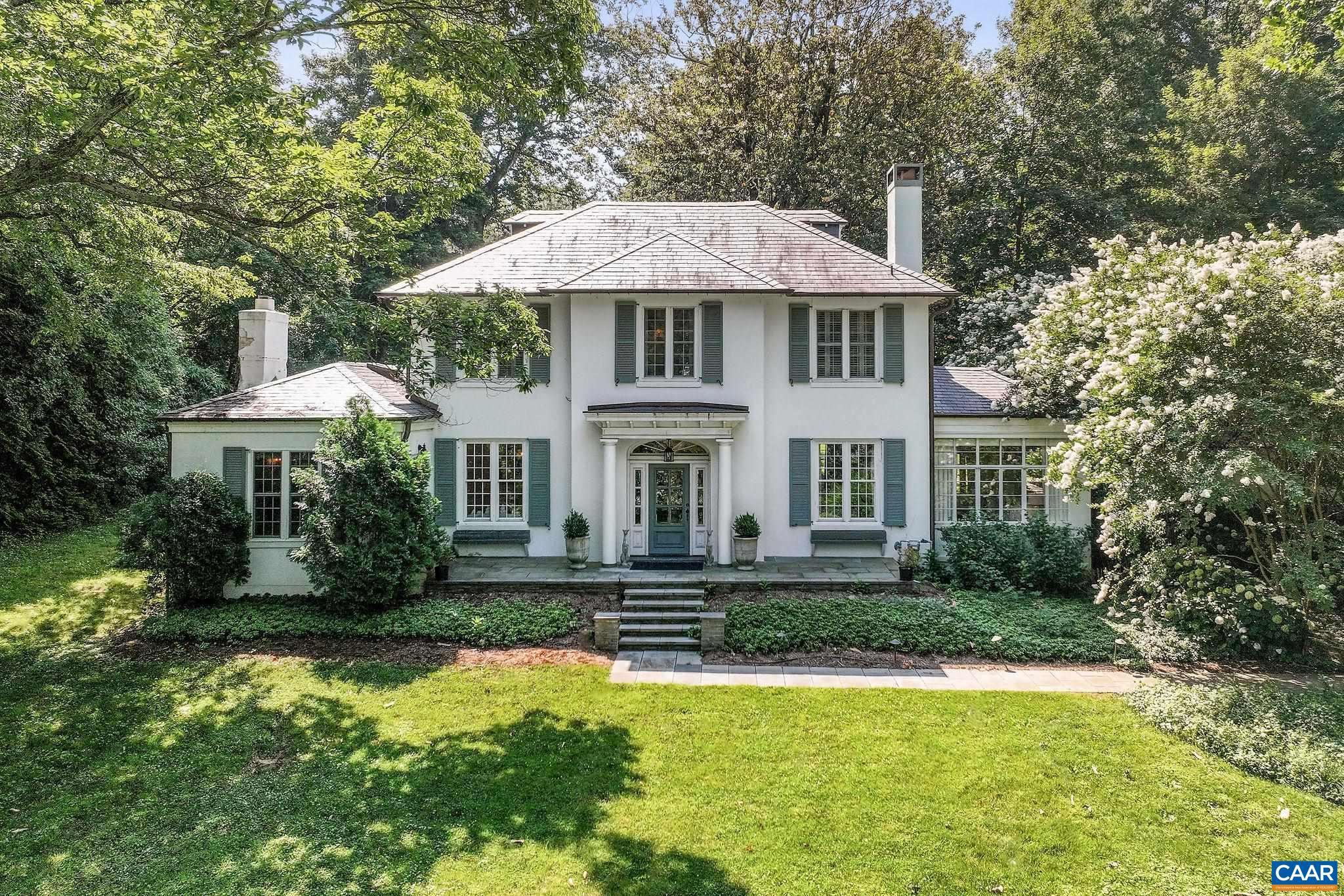 Introducing Magnolia Hill, a timeless home set back off one of Charlottesville?s most sought-after streets in the heart of the Barracks/Rugby neighborhood. This classic property has been thoughtfully updated to offer modern comfort while preserving its original character. The kitchen features custom cabinetry, a large center island, and top-tier appliances, connecting easily to multiple living and dining areas. Main and second-floor primary suites provide flexibility for everyday living or hosting guests. A detached guest cottage includes a bedroom, full kitchen, bath, and dedicated home office?perfect for visitors or working remotely. Outdoor living is just as inviting, with bluestone patios, a saltwater endless pool, fire pit, sport court, and dining area, all surrounded by mature landscaping. Just minutes from UVA and downtown, in one of the city's most established and desirable neighborhoods.