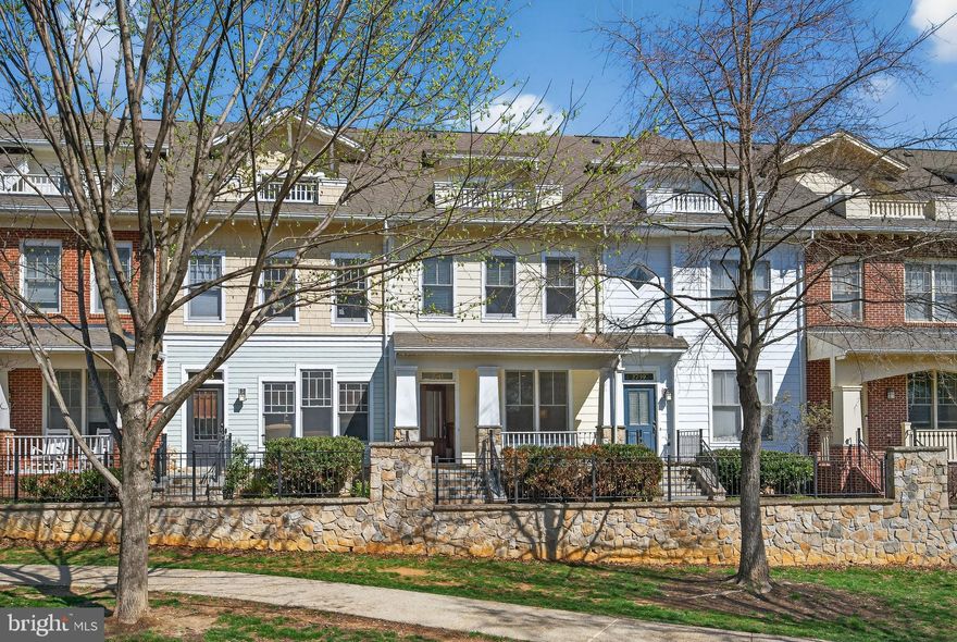 Experience elevated urban living in one of Clarendon’s most sought-after communities with this stunning four-level townhome offering 3 bedrooms and 3.5 baths. Perfectly positioned along the greenery of 11th Street Park, this home blends serene outdoor surroundings with immediate access to the vibrant energy of Clarendon. Filled with natural light, the home features an open, airy layout complemented by gleaming hardwood floors throughout the main and upper levels. The main living and dining spaces flow effortlessly into a beautifully appointed kitchen with granite countertops, a center island, gas cooking, crisp white cabinetry, and a spacious breakfast area. Just beyond, one of two outdoor decks creates a seamless indoor-outdoor connection, ideal for both everyday living and effortless entertaining. The primary suite is a true retreat, highlighted by a bay window bump-out, an expansive walk-in closet, and a fully renovated spa-like bath featuring a freestanding soaking tub and glass-enclosed shower. A secondary bedroom with its own en-suite bath and bedroom-level laundry provides both comfort and convenience. The top level offers a private suite with vaulted ceilings, a full bath, and direct access to the showstopping rooftop terrace. Here, take in sweeping, unobstructed views of the Washington Monument and U.S. Capitol, an unforgettable setting for entertaining or unwinding above the city. On the lower level, a warm and inviting recreation room with a gas fireplace opens directly to the oversized two-car garage, while a charming slate front porch overlooks the park, adding to the home’s distinctive appeal. Located just two blocks from the Clarendon Metro, this exceptional residence offers walkable access to Arlington’s best dining, boutiques, and everyday conveniences, including Whole Foods and Trader Joe's, delivering a rare combination of tranquility, connectivity, and refined city living.
