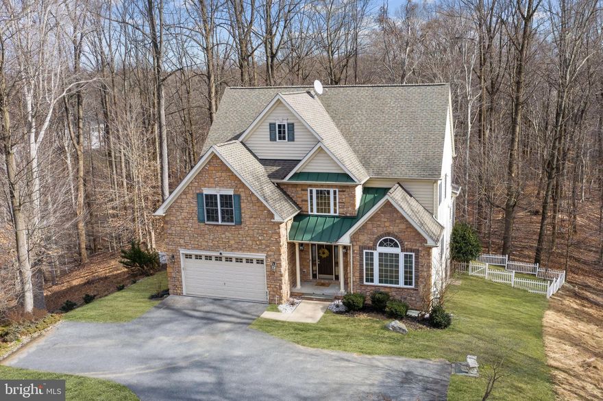 Offer Deadline Monday 2/8 at Noon. Pristinely maintained boasting quality finishes nestled in the sought after Autumn View community! Located on a private lot backing directly to over 30 acres of wooded Howard County parkland! Boasting gorgeous hardwood floors, soaring ceilings, crown molding, chair railing, architectural columns, sunbathed windows, and 1G Optic connections installed in the living room and lower level! Formal living and dining rooms perfect for entertaining family and friends. Prepare savory meals in the stunning kitchen highlighted with granite counters, energy efficient stainless steel appliances, Monogram six burner gas stove, center-island, breakfast bar, pendant lighting, walk-in pantry, a casual dining area and deck access. The adjacent two story family room is complemented with a stone profile gas burning fireplace, ceiling fan, and an adjoining den or study. Travel upstairs to find a sprawling primary bedroom adorned with a cathedral ceiling and a walk-in closet. Luxurious en suite bath embellished with dual vanities, soaking tub, a glass enclosed shower, and a water closet. Three vastly sized bedrooms, and a full bath, complete the upper level. The impressive lower level provides an exceptional recreation room with a gas burning fireplace, fifth bedroom, dual entry bath, storage room, and walkout level access! Enjoy the sun rise and set from the comfort of the expansive rear Trex deck or patio overlooking landscaped grounds and a fenced yard. Amazing community amenities including a dog park, community pool, gym, tot lot, and more it just doesnt get any better than this!