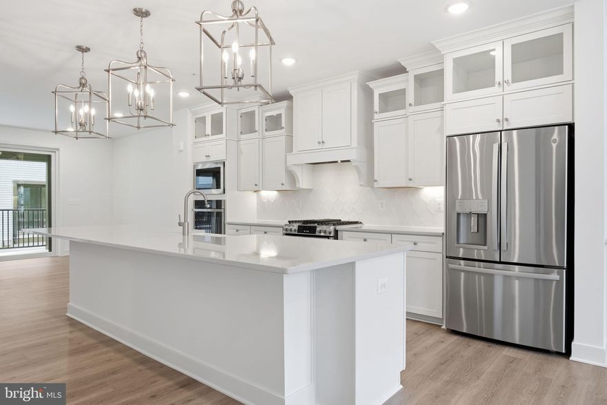 Move-in ready and already completed, this Montvale model at Locke Landing offers a great opportunity to own a brand-new two-story condo in the heart of the Baltimore Peninsula. Timeless design meets modern comfort in this stunning home, set within one of the city’s most exciting waterfront communities.
The main level features a spacious, open layout centered around a gourmet kitchen where Brellin White cabinetry & brushed nickel pendants elevate the space. Quartz countertops, ceramic tile backsplash, pantry storage, and stainless steel appliances complete the look, while a spacious island serves as a prep space & casual dining area. The dining area & great room flow seamlessly to the covered balcony, making it easy to entertain or unwind while taking in water and city views. Luxury laminate plank flooring runs throughout the main living areas, bedrooms, and upstairs hallway for a clean, cohesive feel.
Upstairs, you’ll find three generously sized bedrooms, a versatile loft area, and a convenient laundry room with washer and dryer included. The primary suite with dual walk-in closets for ample storage feels like a true retreat, complete with a spa-inspired bath featuring dual vanities, quartz counters, and a walk-in ceramic tile shower with a built-in seat.
One of the standout features of this home is the rooftop terrace offers a private outdoor escape, complete with sweeping panoramic views of the harbor and city skyline. Enjoy views of M&T Bank Stadium, Oriole Park at Camden Yards, McHenry Row, the Under Armour campus, and sight lines stretching toward the Francis Scott Key Bridge — an ideal setting for sunsets, entertaining, or quiet evenings under the stars.
Locke Landing overlooks 2.5 miles of restored waterfront and is planned to include a future clubhouse, fitness center, outdoor pool, and a 2.2-mile walking trail encircling the peninsula. Each home includes an oversized one-car garage with EV charging capability, along with open common green spaces throughout the community.
You’ll also enjoy unmatched access to Baltimore’s social scene, including Nick's Fish House, The Rye Street Tavern, Slutty Vegan, Jersey Mike's, Ben & Jerry's, and The Daily Grind, along with waterfront wellness events, food truck Thursdays, and seasonal festivals. Also just a few minutes from the beautiful historic neighborhoods of Federal Hill and Locust Point.
This specific home is fully completed and ready for immediate move-in, offering a rare opportunity for a quick and seamless settlement into brand-new waterfront living.