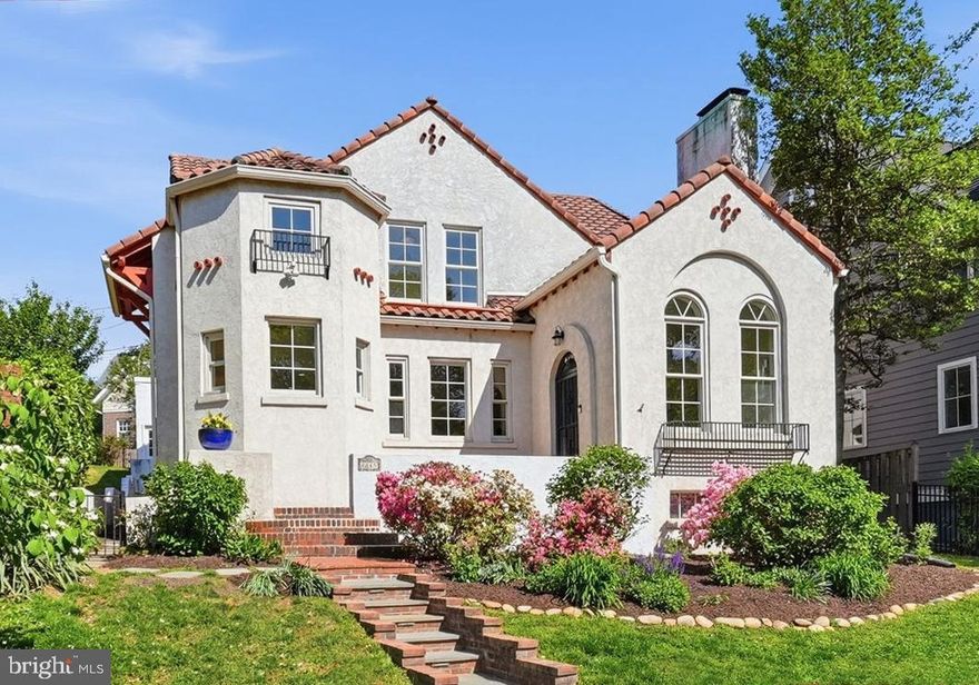 A Lyon Village Gem!
Step into the charm and character of this beautifully preserved 1929 Spanish Bungalow, offering 5 bedrooms, 4.5 baths, and just under 3,900 square feet of inviting living space. Rich in architectural detail, the home showcases classic white stucco walls, a red terracotta tile roof, graceful arched doorways, and elegant ornamental ironwork throughout creating a warm, timeless ambiance from the moment you arrive.
Inside, exquisite craftsmanship shines alongside thoughtful updates. The welcoming living room features soaring 11.5-foot ceilings, dramatic Palladian windows, and a stunning kiva-style fireplace while a gracious formal dining room sets the stage for memorable gatherings. The cozy family room—with custom built-ins—opens through French doors to a private patio, perfect for effortless indoor-outdoor living.
At the heart of the home, the spacious kitchen offers top of the line appliances an expansive island, abundant storage, a pantry, and a charming breakfast area framed by a bay window and arched entry. 
The main level is completed with two bedrooms—one ensuite—providing flexible living options, and a stylish powder room.
Upstairs, a serene primary suite, which boasts a fireplace, walk-in closet and a spa-inspired bath with soaking tub, glass-enclosed shower, and double vanity. Two additional bedrooms, one with a delightful window seat share a Jack-and-Jill bath, along with a whimsical hidden playroom featuring custom built-ins. A conveniently located laundry room completes the upper level. Additional highlights include hardwood floors, new carpeting in select bedrooms, a terracotta-tiled lower level with abundant storage, and a two-car garage.
Outside, enjoy private, shaded outdoor living spaces surrounded by mature landscaping and a fully fenced yard—ideal for relaxing or entertaining. 
Perfectly positioned across from the Lyon Village playground, just blocks to the heart of Clarendon with shops, dining, gyms and Metro, this home offers a rare blend of historic charm, modern comfort, and an unbeatable location.