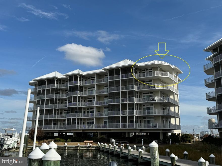 This beautiful corner unit of Harbour Lights Condos overlooks the Tangier Sound and vast Chesapeake Bay waterways.  Being a corner unit, this condo comes with an oversized balcony that wraps around given access from both the living room and dining room.  The attached screen room gives access to the primary bedroom.  Large open floorplan includes a full kitchen, dining room, and living room.  Fireplace in the corner of the living room adds to the surrounding views.  Located in town of Crisfield gives plenty of access to shopping, restaurants, and fun amenities.  Enjoy watching the boats and watermen passing by in the sound.  This unit comes with its own boat slip (E5) which is located just outside the main building.  Community pool, docks, and piers.  Covered parking under the building with code/keycard access to building.  Elevator for easy access and entry.  Most furniture conveys and this unit has a rental history.  Don't miss the opportunity to make these beautiful sunset views your own.