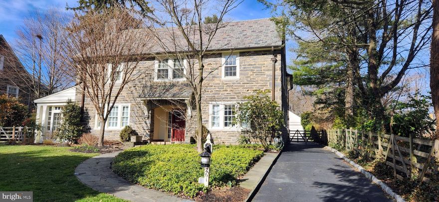 A classic, pedigreed six bedroom center hall colonial, with 1920's grandeur and scale, constructed of hand cut Pennsylvania field stone with a slate roof.  Detached garage with private driveway, additional parking area, and turn apron.   Overall, an enchanting property with a slightly raised, level lot, mature perimeter hedgerows and trees for privacy,  generous flagstone patio with fountain and gardens, and deep, fenced rear yard and lawn, all professionally landscaped.  This special location on Kent Road also backs to a preservation meadow for additional privacy and is well-located within one of the best and most cherished family neighborhoods on the Main Line. Wide and quiet leafy streets with sidewalks and beautiful historic homes within easy walking distance to SEPTA (7 mins), Suburban Square (10 mins) and LMHS (10 mins). The best that Wynnewood, Narberth and Ardmore have to offer for markets, shopping, brewpubs and bars, venues and restaurants with walk-to convenience.  Located within LMSD's high school choice 'green zone'.

Recessed front stone portico to front door with glass sidelights. Center entrance foyer with in-laid hardwood floors t/o has transverse staircase and coat closet. Front to back living room has stone fireplace, large windows and double French doors leading to the adjacent family/sun room which opens to the rear patio.  Formal dining room has beautifully styled windows and opens to the modern, eat-in kitchen with back stairs, mud room, powder room and back and side doors to patio and garage.  Kitchen has updated white tile backsplash, quartz counters, double sinks, gas range, and lovely, recessed windows.  On the second floor, three family bedrooms share a full, redone hall bathroom. The large owner's suite has a private full bathroom, a WIC and an inner door connecting to the adjacent 'nursery' bedroom, office, or owner’s retreat room. The third floor has two bedrooms sharing a full hall bath.   Lower level has finished rec room area with a half bath, the laundry and then storage and mechanicals rooms.