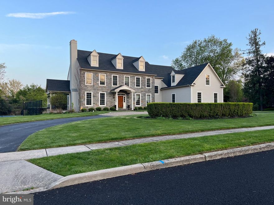 Indulge in an opulent lifestyle with this stunning, custom built Colonial by Wittemann  Architects.  Every inch of this home showcases the expertise of a skilled designer.  This property has been upgraded with the finest materials including a combination of Pennsylvania Wissahickon  Mica Schist stone  and premium Hardie Board that exudes enduring charm.   The owner spared no expense with the new roof and windows.   Situated on a prime cul-de-sac spanning 1.7 acres, this home offers exceptional outdoor living.  Step out onto the rear patio to enjoy the inviting heated saltwater pool and spa, complemented by a built-in gas grill, landscape lighting, and a prepped foundation for a Pool House.  Additionally, a Tennis Court for your enjoyment or line for Pickle Ball Court.   Open the front door to view the spectacular center hall floor plan. The first floor boasts a formal living room with a fireplace, formal Dining Room adorned with beautiful lighting and a sunken family room with a fireplace and built ins.   The gourmet kitchen with center island and large eat-in area is ready for your touch.  Nestled on this level alongside a private office that is perfect for working from home, there's a powder room, mud room with access to the three-bay garage, and a bonus back staircase. The Primary Suite is a sanctuary with an en-suite, spa inspired bathroom featuring a freestanding rainfall shower and frameless glass shower doors, dekton flooring and vanity, walk in closets, a dressing room, and a sitting room.  The second and third bedrooms share a connecting bath, while the fourth bedroom provides a comfortable space for guests with its own full bath.  An additional fifth bedroom or flex room is off the  laundry.  The laundry room is also on this level.   There is more to discover with an additional 700 sq. ft. attic  ready  to finish, electric & cable in place,  great for au pair's suite, additional bedroom or can be a fun den.  The lower level has a game playroom, with wood burning stove, 2 storage areas, powder room and a perfect spot to install a wine cellar.   New Heater & Air Conditioning.  This exclusive property offers an unparalleled location with proximity to prestigious private schools, & access to sought after Wissahickon School District, minutes from the charm of downtown Ambler, Springhouse Village featuring Whole Foods and Starbucks.  This property blends timeless elegance and modern convenience, offering a lifestyle of unmatched sophistication.  Schedule your appointment today.