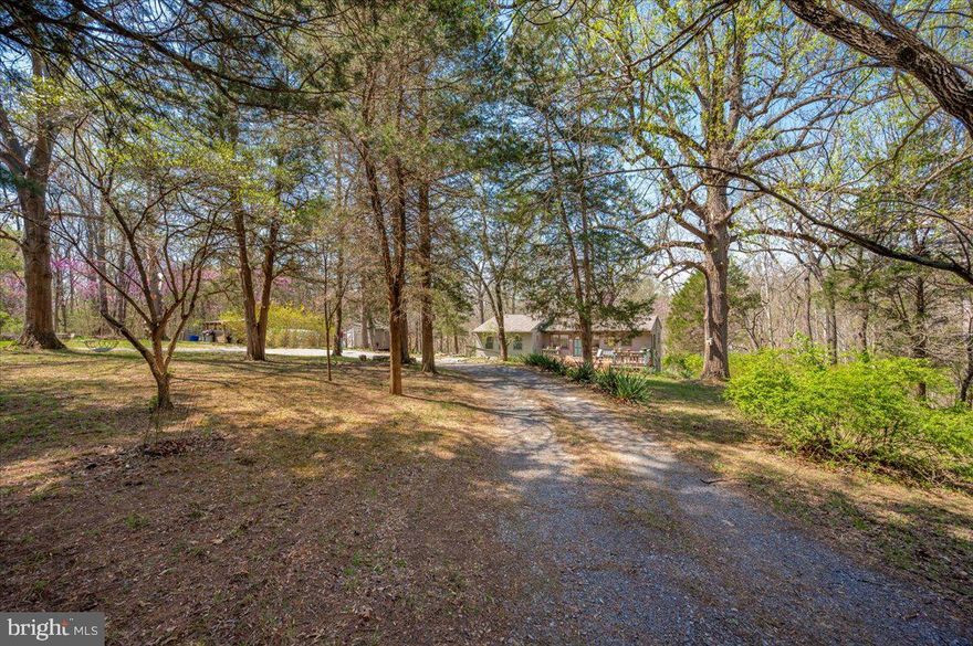 Welcome to this pretty 3 bedroom, 2 full-bath ranch home sitting on 3.46 private creekfront acres.  Call it home or call it your getaway.  Situated towards the end of a quiet roadway in the sought-after country community of Horseshoe Bend!  Country-living at its very best.  When you pull in the circular drive, you will notice a spacious front deck welcoming you.  It opens to a central living room, with two bedrooms and one full bath to the left.  To the right you will see the kitchen, another full bath, and access to lower level through a pretty French door.  Located on the  light-filled lower level is a walk-out to the back acreage, an additional bedroom, a huge family room, laundry facilities, and a bonus room now used for storage.  Creek views are visible from the home when the leaves are down.  Outside is a spacious yard for play and entertaining.  To the left of the home is an oversized workshop sitting close to the garden.   A path to the right of the home leads you to a small hike down to the creek and spacious creekside resting area--perfect to sprawl out with a picnic or beverages.   Or, keep your floats and fishing rods close for adventures!  In addition to your own private 3.5+/- acres, just one parcel beyond is 42 community acres along Sharmans Run (an offshoot from the creek) to hike and explore.  Or enjoy the 32 +/- community acres just down the way for fishing, floating, walking, or just enjoying.  The HOA tends to the roadways and upkeep of community land.  Bring your pets, chickens, horse, and other critters.  Spend a little time enjoying seclusion.  Own your own hide-away for part-time or full-time living at its best.