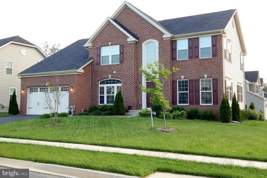 Beautiful brick front colonial situated on a wonderfully maintained level lot