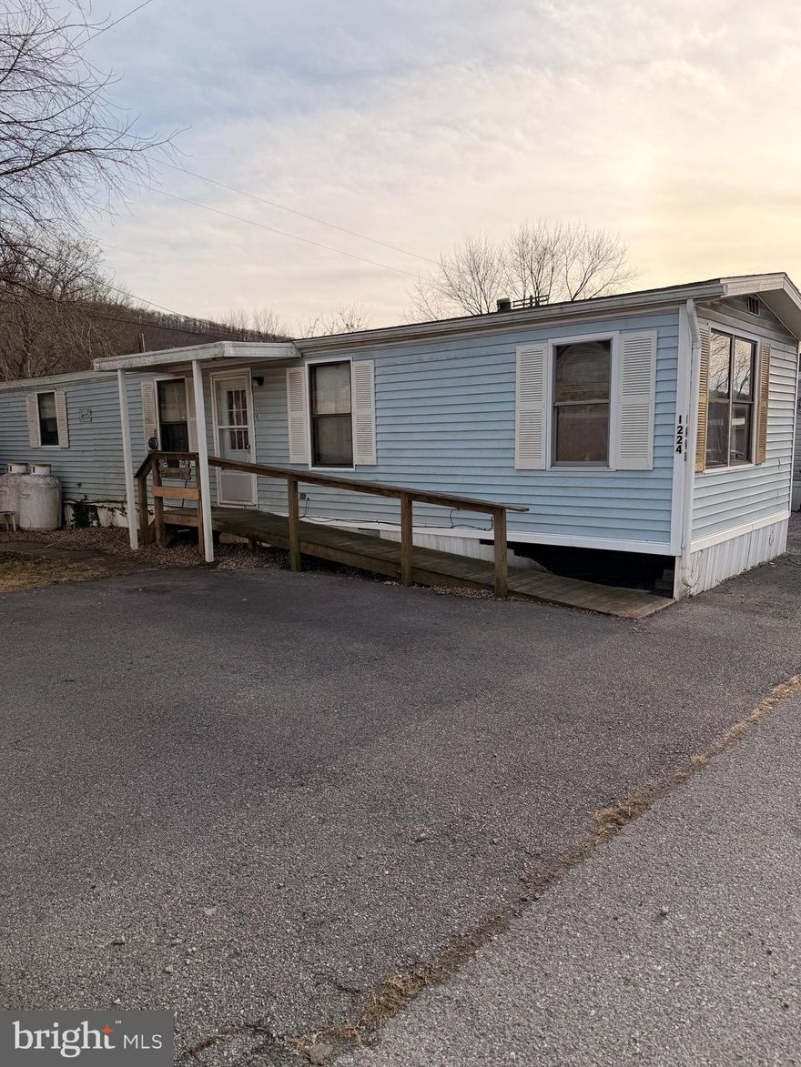 Low Low lot rent $370.00! Manufactured home located in a quiet park in Exeter Township. It needs a little love but nothing to substantial. This three bedroom two bath home offers an open floor plan with comfortable and functional living space. Enjoy low maintenance living with first floor bedrooms and baths making daily life easy and convenient. The home features a front porch with ramp access and is tucked away in a peaceful setting while still being close to restaurants shopping and everyday conveniences. A great opportunity for easy living in a serene location.