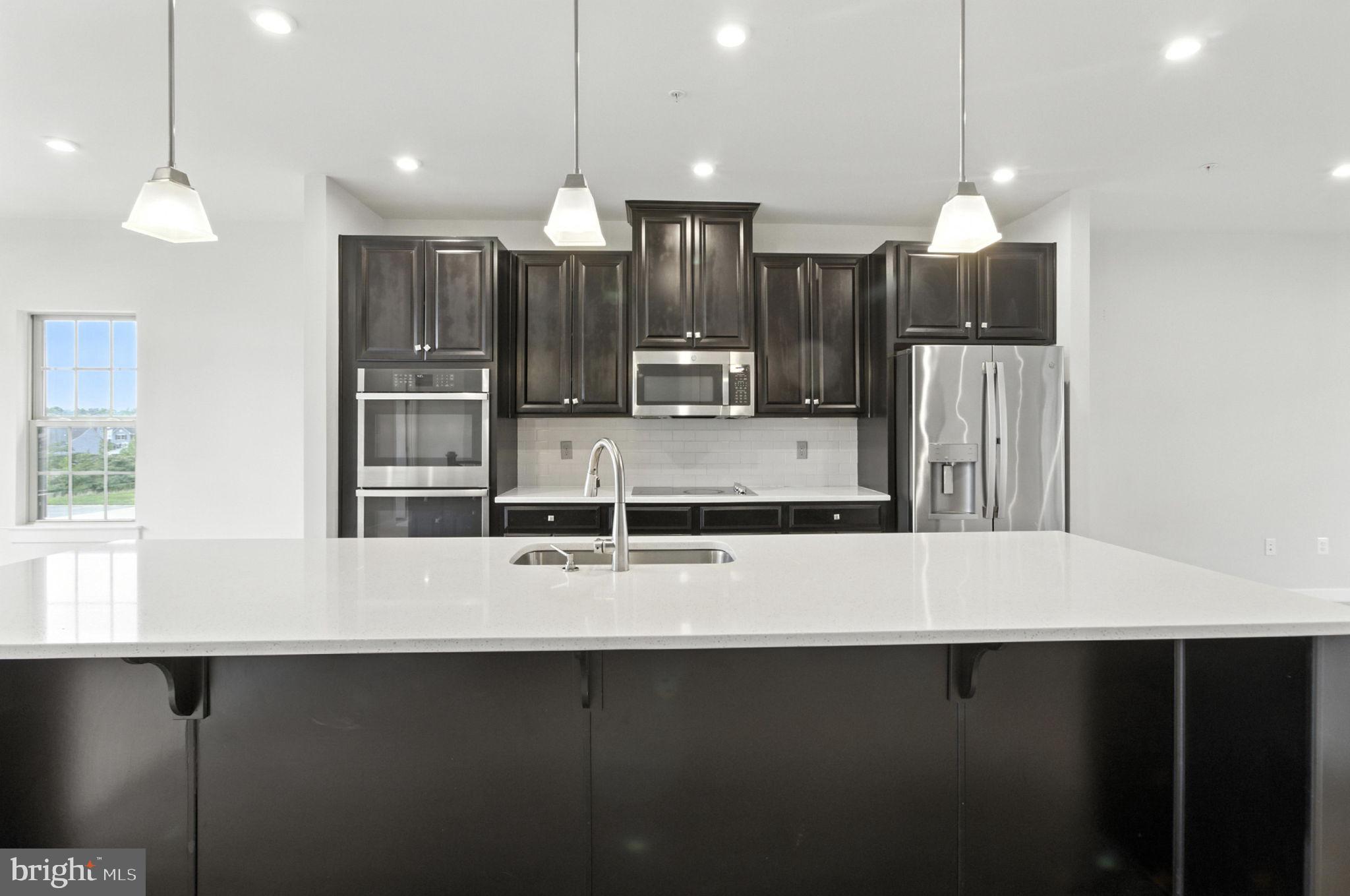 Welcome home to this beautiful 3-bedroom, 2.5-bathroom townhouse/condo in the prestigious Timothy Branch community, built in 2020 by Ryan Homes. With 2300 square feet of living space, this home features an open floor plan, large deck, luxury vinyl plank (LVP) flooring, fresh carpet, stainless steel appliances, and quartz countertops in the kitchen. The primary suite offers a spa-like retreat with a Roman shower and plenty of closet space. The one-car rear access garage adds convenience. This end unit also makes it convenient for rear and front door access. Residents enjoy access to the community clubhouse with a pool, fitness room, and event space. Located within walking distance of Brandywine Crossing, you'll have easy access to Target, Safeway, Bonefish Grill, and more. Don't miss this opportunity to own in one of Southern PG County's most sought after neighborhoods! Seller closing help is offered to buyer.