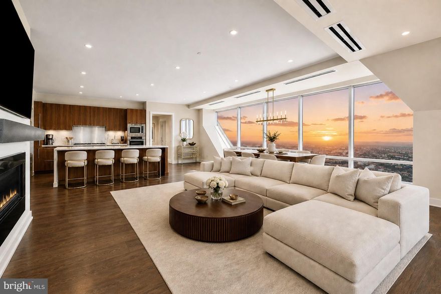Introducing a refined opportunity at The Residences at Two Liberty, perched on the 55th floor. This exceptional 3-bedroom, 3.5-bath residence offers a thoughtfully designed layout with sweeping water views and dramatic city skyline exposures.
A gracious entry foyer leads into a sleek, fully equipped gourmet kitchen that opens seamlessly to an expansive living and dining space, framed by floor-to-ceiling windows and anchored by a modern fireplace—ideal for both entertaining and everyday living.
Two permit parking spaces are available  (inquire with listing agent for fee details), with the potential for an additional space.
Perfectly positioned in the heart of Center City, the home is just moments from Rittenhouse Square, renowned dining, luxury retail, and cultural destinations, with 30th Street Station less than 10 minutes away for easy access to New York and beyond.
Residents enjoy a full suite of amenities including a 24-hour fitness center with panoramic views, indoor pool, steam rooms and saunas, yoga studio, private massage rooms, business center, boardroom, media lounge, and billiards room. White-glove services include a 24-hour concierge and chauffeur-driven Mercedes town car.
Pet-friendly and part of the exclusive Penthouse Collection, this residence offers a sophisticated, turnkey lifestyle at one of Philadelphia’s most sought-after addresses. Photos of unit are virtually staged.