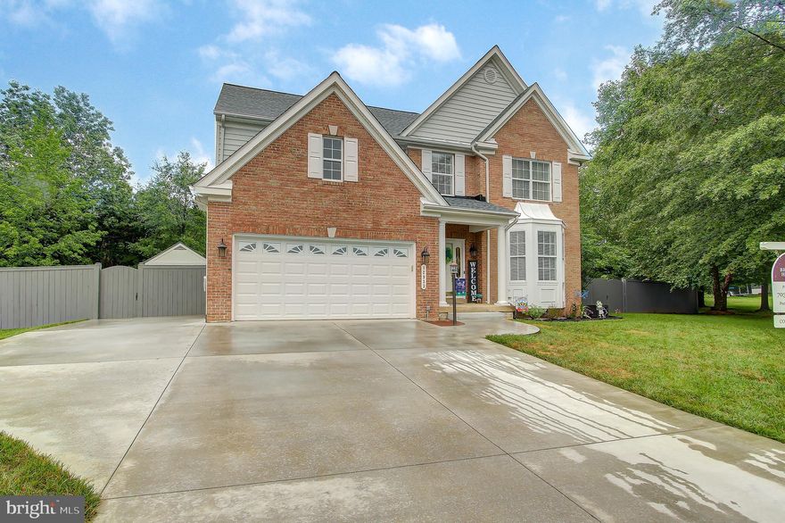 Multiple Escalating Offers Received and awaiting ratification. Don't miss out on this beautifully maintained and spacious brick front colonial located in the highly sought after Charles J. Colgan school zone. Make this home the first stop on your list as we don't expect it to be available long considering all that it has to offer while being in a desired neighborhood with NO HOA. With nearly 2500 finished square feet on the upper two levels alone and a fully finished walk up basement with over 1000 square feet of additional living space, this home is more spacious than one would assume from the exterior. Hardwood flooring flows throughout the entire main level including the foyer, kitchen, family room, formal dining room, separate breakfast room and office. The kitchen with its stainless steel appliances, island w/ bar top, solid surface countertops and 42" cabinets opens to the family room and breakfast room with no shortage of natural light, gas fireplace and direct access to the beautiful stamped concrete patio. On the upper level you will find a spacious master suite with a soaking tub /separate shower, double vanity and a walk-in closet. Three other good sized bedrooms, another full bathroom w/ double sinks and laundry are located on the upper level as well. The fully finished basement with a third full bathroom offers a multitude of possibilities with its large recreation area and separate area perfect for a media room. Two additional finished rooms that could be utilized as a 5th bedroom (NTC) and a second office/storage . The fully fenced and flat back yard at the end of the cul-de-sac  makes it perfect for entertaining. In addition to the oversized two car garage, the extended concrete driveway that wraps around the front side of the house provides ample parking for family and guests during weekend get togethers and holidays.