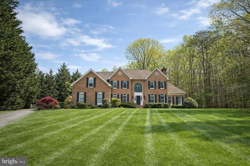 Some homes impress. Others stop you in your tracks. This is one of them. Set on two private acres in a secluded, pristine setting, this extraordinary 5-bedroom, 5.5-bath estate delivers the kind of refined luxury and effortless living that buyers rarely find—especially in this condition. Every inch has been thoughtfully reimagined with a recent, high-end renovation that leaves nothing to be desired. At the heart of the home, a stunning brand-new gourmet kitchen anchors the main level, showcasing quartz countertops, a designer sink, premium chef grade appliances and elegant stone tile flooring. Just beyond, the beautifully remodeled morning room is flooded with natural light and opens to an expansive deck with built-in bench seating, overlooking a private, fenced, level rear yard with ample space for a future pool—creating the ultimate indoor-outdoor lifestyle. The family room is both dramatic and inviting, featuring soaring vaulted ceilings and a floor-to-ceiling stone wood-burning fireplace, while the grand two-story foyer introduces a layout designed for both entertaining and everyday elegance. Formal living spaces are warm and welcoming with an additional fireplace  and a main-level office with custom built-ins offers the perfect work-from-home retreat. A rare and highly desirable feature sets this home apart—a spacious main-level bedroom with a large walk-in closet and a beautifully renovated full bath, offering ideal flexibility for guests, multi-generational living, or a private secondary suite without compromise. Upstairs, the owner’s suite is nothing short of spectacular—a true private retreat with a fireplace, sitting room, tray ceiling, and a completely renovated, spa-inspired “super bath” featuring an oversized multi-head shower designed for total relaxation. The second level is thoughtfully designed to accommodate both privacy and functionality, featuring an additional private bedroom suite with its own ensuite bath, while the third and fourth bedrooms are connected by a well-appointed Jack and Jill bath. The fully finished walk-up lower level transforms the home into an entertainer’s dream, complete with a custom granite wet bar and expansive recreation space creating a turnkey experience that is virtually unmatched. Daily living is elevated with a three-car side-load garage, a functional mudroom with built-in storage for backpacks and sports gear, and a fabulous laundry room designed to handle real life with ease. With  generous parking, and a setting surrounded by other fine homes, this property offers both privacy and prestige—while remaining incredibly convenient to Washington, Baltimore, Northern Virginia, and multiple major airports. This is more than a home—it’s a statement, a retreat, and an opportunity. If you’ve been waiting for something truly exceptional—this is it.