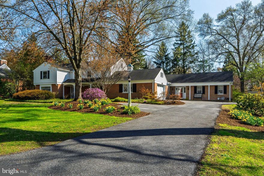 Spacious & Elegant Home in Prestigious School Lane Hills. The beautifully landscaped .76-acre lot is shaded by mature trees and vibrant gardens, creating a tranquil outdoor retreat. Step into this beautifully maintained, quality 5-bedroom, 3.5-bath home offering 4,513 Sq. Ft. of comfortable living space in the
serene neighborhood of School Lane Hills. The welcoming open slate foyer invites you into a grand sun-filled living room with windows featuring a panoramic view. The rich hardwood floors and recessed lighting accentuate the classic brick fireplace — perfect for relaxing or entertaining guests. Discover the elegant flow into the versatile library with its wall of built-in book shelves. Adjacent sits the convenient first-floor sunroom with a wet bar and patio access, ideal for work or relaxation. Enjoy making culinary creations in the Quality Custom Cabinetry kitchen. The kitchen boasts a center island, Corian countertops, an additional pantry, and stainless steel appliances. The cozy breakfast nook, illuminated by a skylight, is marvelous for casual meals and enjoying warm sunshine. French doors lead into the formal dining room with it’s Bay window, built-in display cabinet, hardwood floors, chair rail, and crown molding, it provides an inviting space for larger gatherings. Entertainment is effortless with a large first-floor family room off the kitchen, featuring a vaulted ceiling, ceiling fans, recessed lighting, built-in bookshelves, generous storage, and access to a oversized stamped concrete patio — superb for outdoor entertaining.
A special highlight is the separate private living area, perfect as in-law quarters with its own private entrance, porch, patio, two bedrooms, and a full Jack & Jill bath — offering privacy and comfort for guests or extended family. Upstairs, the spacious primary suite includes a private bath, walk-in closet, and plenty of additional storage. Two sizable bedrooms with double closets and a full hall bathroom. The basement consists of a large finished room and two additional storage rooms. Plenty of parking with the attached 2-car garage and additional off-street parking spaces. The separate backyard storage shed is convenient for all your gardening needs. This exceptional home offers a perfect balance of spacious entertaining areas and cozy family comfort — a true gem awaiting its new owners. The School Lane Hills neighborhood is a prestigious well-established community located 2 miles West of Lancaster City. This impressive home is conveniently located near Lancaster Country Day School and the New School Montessori. It offers easy access to downtown Lancaster and minutes from Routes 30, 283 and 222.