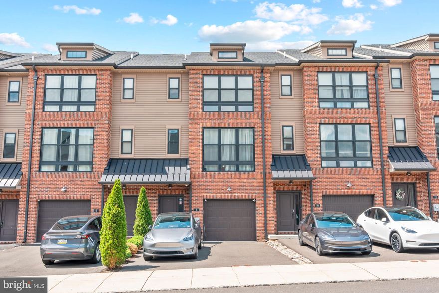 Tucked within the highly coveted Brickyard community, this exceptional four-story townhome is a rare blend of modern sophistication and thoughtful design. Every level of this beautifully upgraded home has been curated for both style and functionality, offering a lifestyle of comfort, convenience, and elegance.

Upon entry, you're welcomed by a spacious foyer featuring rich hardwood floors and a bright, open ambiance that immediately hints at the home’s refined character. The entry-level offers remarkable flexibility, ideal for a guest suite, home office, or second living space, with its full bath and direct walkout to the backyard. This level also includes a laundry area, mechanical room, and an oversized one-car garage for easy day-to-day living.

Upstairs, the second floor unveils the true centerpiece of the home. Soaring ceilings, hardwood flooring, and an exposed brick feature wall provide a stunning backdrop for the open-concept kitchen, living, and dining areas. The chef’s kitchen is equally impressive and highly functional, outfitted with 42-inch cabinetry topped with crown molding, quartz countertops, a sleek tile backsplash, premium stainless steel appliances, and a generous center island perfect for gatherings. A charming sliding barn door reveals a built-in pantry, and sliding glass doors lead to a private deck—ideal for dining under the stars or relaxing with a morning coffee. A stylish powder room rounds out this floor.

The third level is devoted to rest and retreat, offering three well-appointed bedrooms and two full bathrooms. The primary suite impresses with vaulted ceilings, dual closets, and a spa-inspired ensuite that provides a peaceful escape at the end of the day. One of the secondary bedrooms features a whimsical, hand-painted mural, adding a unique, artistic touch that makes the space truly one of a kind. Each room is finished with attention to detail and cohesive design, making every corner feel intentional and warm.

The top floor truly elevates this home, featuring a bright and airy bonus space complete with a built-in wet bar, beverage fridge, and a stunning custom accent wall that adds character and charm. Step outside to the private rooftop terrace, perfect for entertaining guests, enjoying peaceful sunsets, or unwinding with a good book under the stars.

Located in the desirable Neshaminy School District and close to major commuter routes, shopping, dining, and everything Bucks County has to offer, this townhome delivers an unbeatable combination of low-maintenance living and high-end finishes. With the HOA handling lawn care and snow removal and guest parking just steps away, this move-in-ready gem is the perfect place to call home.