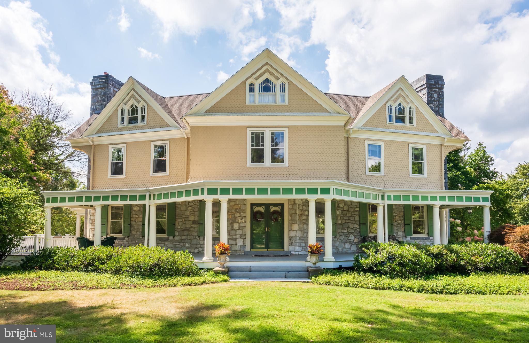 Welcome to 312 S. Waterloo Road, a magnificent home in the heart of Devon’s estate section. It’s an often-used phrase, but in this case it’s true: this is a once-in-a-lifetime opportunity! The home is a seamless blend of Old World charm and modern expansion—the very best of both worlds. The wrap-around covered front porch sets the stage. Step inside to the gorgeous entrance hall with its fireplace, gleaming hardwood floors, and an extraordinary hand-carved wood staircase that rises three full levels. This staircase, crafted by artisans, is a true masterpiece. Throughout the home you’ll find incredible detailing and a warmth that blends elegance with comfort. The formal living room with fireplace and the expansive dining room—also with fireplace—are ideal for holidays and family gatherings. A tremendous family room addition with soaring tray ceiling and fireplace offers sweeping views of the grounds. The kitchen itself is the heart of the home, with a massive granite center island, abundant raised-panel cabinetry, generous counter space, tiled backsplash, and top-tier stainless steel appliances. Off the kitchen, a huge breakfast room with built-in bookshelves is filled with natural light. A true butler’s pantry connects the kitchen to the dining room for seamless entertaining. Two powder rooms complete this level. Up the incredible staircase, the second floor features a sumptuous owner’s suite with fireplace, walk-in closet, additional custom closets, and an attached dressing room that could also serve as a nursery. The luxurious primary bath includes a marble double vanity and an oversized tile shower. A large second bedroom enjoys its own en suite bath, while a third bedroom—currently used as a home office—is served by a charming hall bathroom. This level also includes a full laundry room. The third floor offers two massive bedrooms serviced by a spacious full bath with soaking tub and shower. Unlike most homes of this era, 312 S. Waterloo Road has a fabulous finished basement with full-size windows and direct access to the rear grounds and patio. Here you’ll also find a powder room, a true, fully conditioned wine cellar, and a very large unfinished storage area. Outdoor living spaces are equally impressive. In addition to the wrap-around front porch, there’s a screened porch off the bar area and a private patio in back—ideal for entertaining, quiet relaxation, grilling, and dining al fresco. And the bonus: above the three-car garage is a true one-bedroom apartment with a full bath, perfect for guests, extended family, or au pair accommodations. 312 S. Waterloo is an extraordinary Main Line classic. Every inch is a gem—more than words can capture here. Experience the perfect blend of luxury, comfort, and lifestyle—this is a home not to be missed. Close to the shops, trains, and restaurants of The Main Line, and located within the highly ranked Tredyffrin-Easttown School District. This is the one. Welcome home!