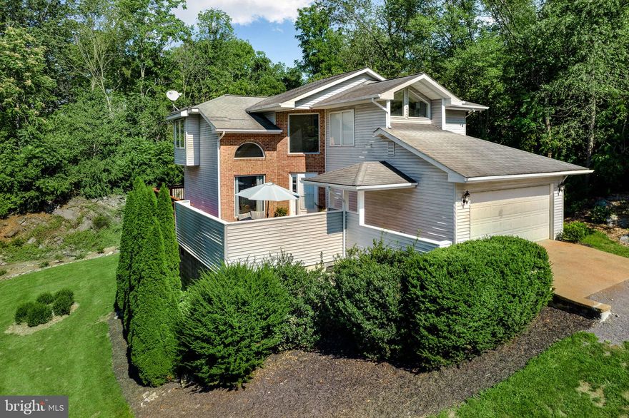 Why Go Anywhere Else? When you can soak up all the Beauty and Privacy this Home has to offer!!! You will enjoy the all the square footage and extras you have in this Beautiful Contemporary Home with 3 Finished Levels, including 4 Bedrooms, 3.5 Baths, Tile Floors in the Kitchen that is open to the dining area, Large Living Room area with Hardwood Floors and  Vaulted Ceilings, Laundry room on Main Level, 2 Garage Garage with loads of storage, Upstairs you have a Large Master Suite with a Spacious Bathroom, plus 2 additional Bedrooms and another full bathroom, Lower level is the 4th Bedroom, 3rd Full Bathroom and Large Family Room that leads out to a patio! Large Back Deck to take in all the nature that surrounds this home! Spacious private front patio for additional outdoor living space and to relax and dine during those Summer and Falls evenings! So many extras ways to entertain and with 3.36 acres of land you have plenty of room for your garden! Don't wait schedule your showing today!