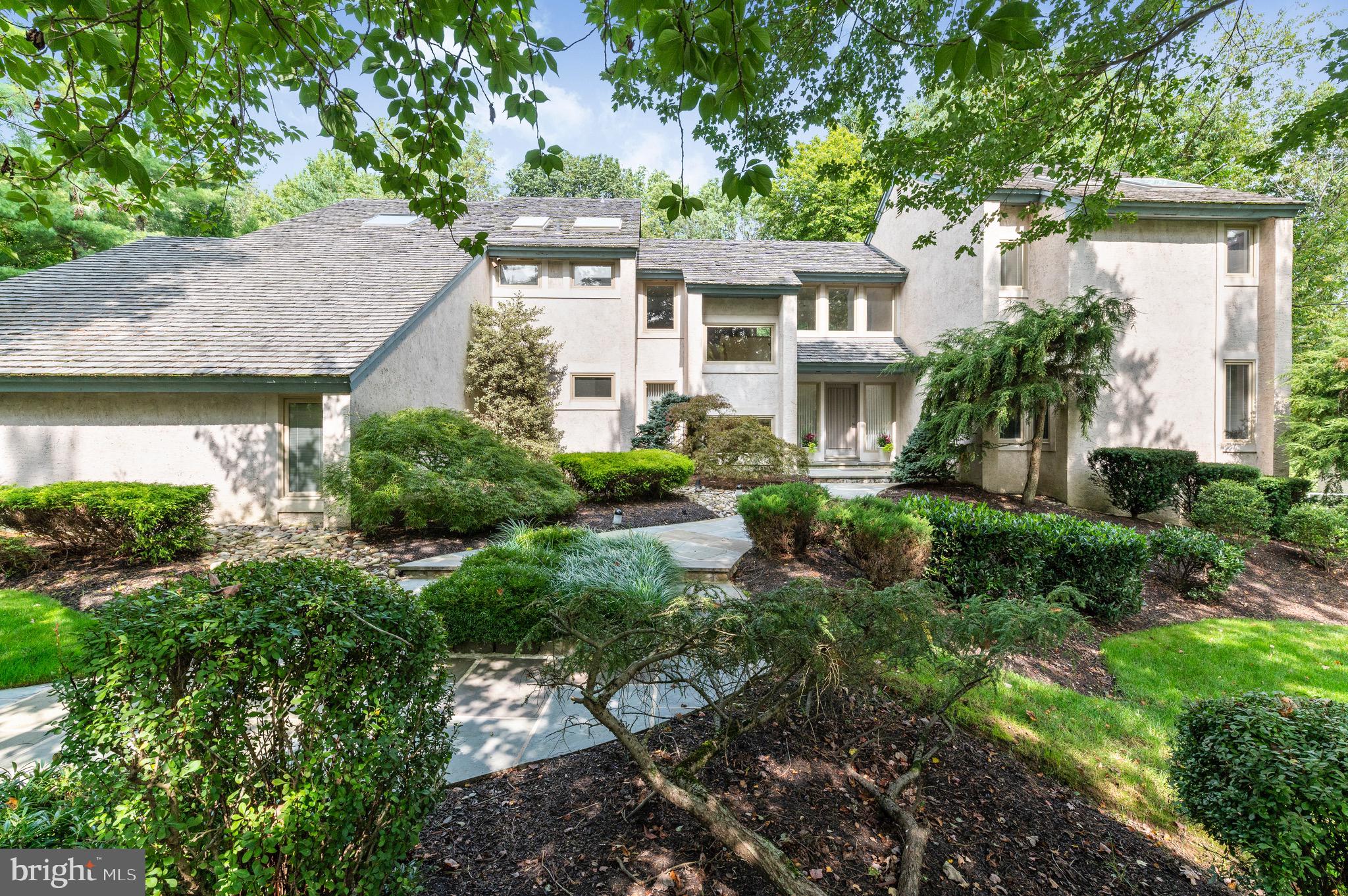 Stunning contemporary home with extraordinary architectural elements in sought after Ravenscliff. Soaring ceilings, oversized windows and numerous skylights create a light filled home with amazing spaces for taking in the views of the outdoors. In a sea of farmhouses this modern beauty truly stands out. Nestled on a private, wooded lot with mature landscaping and specimen plantings this home is a true retreat. The first floor features a dramatic entryway, a large living room with a fireplace and wet bar area perfect for entertaining family and friends. The sunken formal dining room features a dramatic wood ceiling and is just off the kitchen. The incredible kitchen is sleek, functional and beautiful with a large breakfast room flanked by windows and fabulous views of the yard and pool. Open to the kitchen is the family room with a floor to ceiling stone fireplace, built-ins and cozy wood beams. There is also a mudroom and laundry room on the first floor just off the attached 3 car garage. Upstairs you will find the master bedroom with a pristine, remodeled master bath complete with 2 sinks, a walk-in glass shower and soaking tub. There are 3 additional bedrooms on the second floor with a large remodeled full bathroom. The finished lower level features an additional family room that opens right out to the gorgeous backyard and fantastic pool. The 5th bedroom is also in the lower level and is the perfect spot for guests or an au-pair suite. A large full bathroom with a sauna and separate water closet completes the lower level. Located in the award winning Radnor School district, close proximity to downtown Wayne with it's many shops and restaurants, close to public transportation and many of the amazing parks and conserved areas. This one-of-a-kind home is not to be missed!