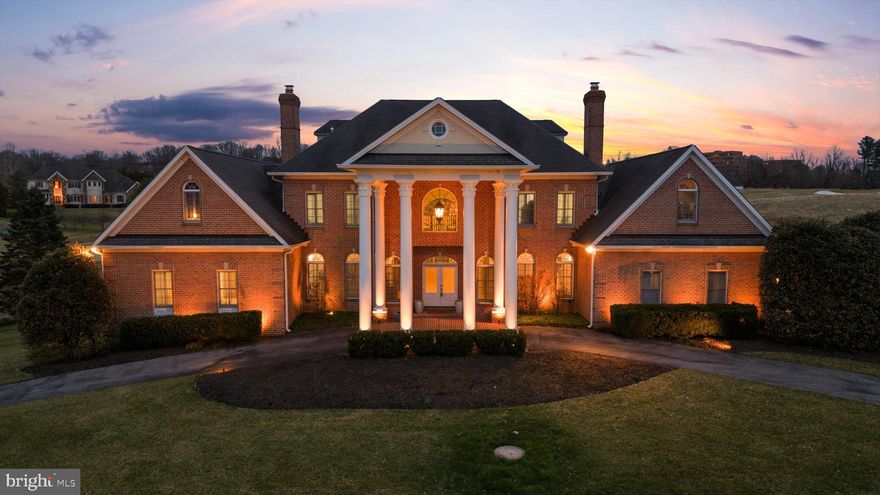 Welcome to 505 Pond View Lane, a stately Georgian manor overlooking the fairways of Hayfields Country Club. Located in the prestigious Hayfields Manor community of Hunt Valley, this exceptional residence offers over 12,000 square feet of grand living and entertaining space across four expansive levels. Now presented with six updated bathrooms and a freshly painted interior throughout, the residence combines timeless architecture with thoughtfully refreshed interiors and renewed presentation. Perfectly positioned along the golf course, the home enjoys sweeping views of lush fairways and a tranquil pond, creating a peaceful backdrop to the main living spaces. A stately columned façade and circular drive introduce the residence, leading into a two story foyer with marble flooring and a sweeping curved staircase that anchors the floorplan. From this central entry, the layout reveals views into the formal living and dining rooms while offering a glimpse into the main living room beyond. Hardwood floors extend throughout the main level, where thoughtfully designed spaces balance elegance with functionality. The residence offers a natural flow between living spaces, creating an inviting layout for both entertaining and everyday living. The double height living room is filled with natural light from expansive windows that frame beautiful views of the fairway, while a striking double sided fireplace creates a warm focal point. A second level balcony overlooks the living room below. Elegant spaces include a formal living room and dining room, each with its own fireplace. At the heart of the home, the gourmet kitchen features a commercial range with hood, double ovens, stainless steel appliances, granite countertops, custom cabinetry, a large center island with prep sink and breakfast bar seating, and a walk in pantry. A wine and coffee bar add convenience, while the spacious dining area provides the perfect setting for everyday meals or larger gatherings. Both the living room and kitchen dining area open to the expansive rear deck and patio, creating seamless indoor outdoor flow for entertaining while enjoying scenic golf course views. The main level primary suite offers a peaceful retreat with a cozy sitting area with fireplace, two large walk-in closets, and private deck access. The spa style bath features updated dual vanities, soaking tub, walk in shower, and a separate water closet. A private study with its own fireplace is located just off the primary suite. The main level also includes a powder room, laundry room, secondary staircase, and an additional full bath with updated flooring and vanity, along with access to the oversized three car garage. The second level offers four generously sized bedrooms, each with an attached bath featuring updated vanities and flooring. Three bedrooms include walk in closets, while the fourth offers ample closet space. A spacious game room completes the level. The third level features another large bedroom suite with its own full bath, closet area, and sitting or media space. The finished lower level adds over 3,700 square feet of living space, including a full kitchen with quartz countertops, recreation areas, gym space, bedroom, and full bath. This level also provides direct access to the covered patio and backyard. Members of Hayfields Country Club enjoy access to championship golf, dining at the Redwood Grille and Hayfields Mansion, swimming, pickleball, bocce courts, and a vibrant social calendar. Conveniently located just minutes from Interstate 83, Hunt Valley Towne Centre, Shawan Downs Equestrian Center & Steeplechase course, and Oregon Ridge Park. Welcome to Hayfields Manor and the lifestyle that comes with living in one of Hunt Valley’s most sought after communities.