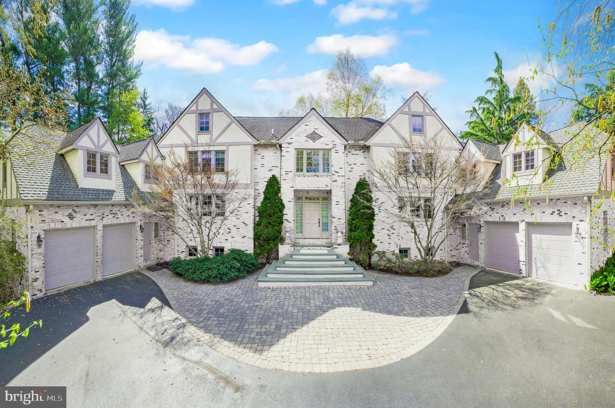 Real estate taxes successfully appealed and reduced to $37,650 effective January 2025. A prominent local real estate attorney believes an additional appeal could result in further reduction. Nestled on 1.4 acres of breathtaking wooded landscape, stately residence on prestigious Mount Pleasant Road offers the ultimate in privacy, elegance, and architectural beauty. A brick-pillared entrance and Belgian block-lined driveway lead to a stately brick Tudor masterpiece, blending timeless charm with modern sophistication.
Step into the grand two-story foyer, where marble floors and exquisite craftsmanship set the tone for this exceptional residence. The library/study, with its coffered ceiling and built-in bookcases, exudes warmth and sophistication. The expansive living room, featuring a fireplace, gleaming wood floors, and a picturesque bay window, offers stunning views of the serene backyard. The formal dining room, bathed in natural light, opens to a private walled patio, seamlessly blending indoor and outdoor living.
At the heart of the home, the soaring two-story family room captivates with its 18-foot ceiling, dramatic bay window, gas fireplace, and custom built-ins. Adjacent, the chef’s kitchen showcases rich cherry cabinetry, a center island, and an inviting solarium, perfect for informal dining with floor-to-ceiling glass doors leading to a secluded deck and patio.
Upstairs, the primary suite is a private sanctuary, offering a spacious bedroom, a sunlit sitting/dressing room, dual walk-in closets, and a spa-like bath, where a bay window frames tranquil views of lush greenery. Four additional well-appointed bedrooms include an en-suite guest room, a princess suite with a walk-in closet, and a separate East Wing retreat, ideal for an au pair, private guest quarters, or a home office.
The West Wing presents a hidden gem—accessed from the courtyard, garage, or private staircase—leading to a large bonus room, perfect for a secluded office, media room, or playroom.
Luxury meets convenience with a Kohler generator, two central vacuum systems, and four-zone heating and cooling, ensuring year-round comfort.
This distinguished property is more than a home—it’s a private retreat, an entertainer’s dream, and a rare opportunity to experience the beauty, tranquility, and gracious living that define Mount Pleasant Road.