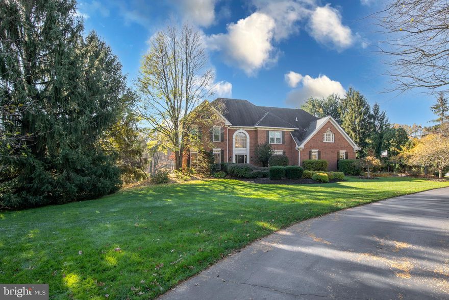 Get ready...here is your dream home! Located in the heart of Historic Bucks County PA is this impeccably maintained, 5BR, 4 full bathroom David Schrenk-built home with over 5000 sq ft of above-ground space and situated on over 2.37 acres of manicured land. Welcome to 107 Whisper Wood Ct! Let's talk about how nice of a setting this property enjoys. At the end of a cul-de-sac on Whisper Wood Court is the entrance to #107! A long, winding driveway circles in front of the house and an old-time brick walkway leads to the main door. Inside, the first thing anyone notices is the signature millwork and hardwood flooring that are standard in any DJS built home. The foyer area reaches two stories in height and has a turned oak staircase set back from the main door. This allows for guests to be greeted with ample space...a key point to know if you entertain. Flanked to the left is the formal living room and to the right the formal dining room. A hallway straight ahead leads directly to the two-story great room filled with walls of windows and gleaming with natural light. The ceilings here are vaulted and there is a cozy propane gas fireplace to snuggle around on a cold winter nights. Perhaps the most enjoyed room in any home is the kitchen, because that is where "it all happens!” It is no different here at Whisper Wood Ct. The large kitchen, with gas stove, double oven and granite counter tops, combined with the breakfast area and sunroom, allows for wonderful conversations and much enjoyment. Now, this sunroom is not like many others...oh no. This one does have walls of windows, but unlike so many, this one overlooks a fenced backyard oasis and a POND. That's right, your very own pond. What a view, and things even get better, because another propane gas fireplace is located in that sunroom and will keep everyone warm on cold days. There is a custom study on the other side of the great room that features raised oak wood panels, detailed moldings and views of the rear yard. This room also has another purpose if needed. It can also be used as a first floor "5th" bedroom, complete with full bathroom and room for a closet. Finally, the first floor laundry with propane gas dryer and a mudroom complete the main level. Upstairs is the primary bedroom suite with sitting room, 2 walk-in closets, coffered ceiling and opulent bathroom. Also on the second level are 3 additional bedrooms and two more full bathrooms. The lower level features incredible living & recreation space. This is a daylight/walkout lower level with an array of windows and French exit-style doors. A unique feature downstairs includes a third propane gas fireplace. The gas and electric lines are in, it just needs to have a fireplace insert of your choosing be connected. Outside features the most beautiful setting and views with that pond, mature landscaped yard, raised deck, and 3 car side entry garage. The maintenance-free raised deck has a propane gas line accessible for you to connect your outdoor grill. Keep peace of mind knowing the house is protected by a propane gas generator! This is a wonderful opportunity to live in the community of Jericho Valley. Award-winning Council Rock schools and Sol Feinstone Elementary. Easy commutes to historic Newtown, New Hope, and Doylestown. Welcome home!