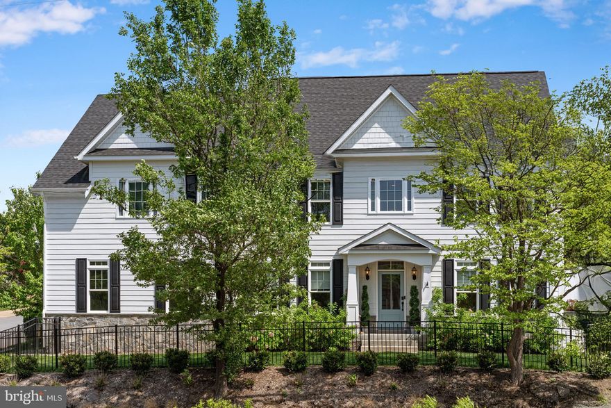 Situated on a landscaped corner lot in Country Club Manor, 4950 34th Street N offers over 4,000 square feet of refined living across three thoughtfully finished levels. Step inside to a wide formal foyer flanked by elegant living and dining rooms featuring tall ceilings, detailed millwork, and abundant natural light.
At the heart of the home, a stunning chef’s kitchen is anchored by a large island with seating and features a 6-burner gas range, brass accents, walk-in pantry, and custom cabinetry. The kitchen flows seamlessly into a dramatic two-story family room with a gas fireplace and second staircase, creating the perfect space for both everyday living and entertaining. A extra large patio offers amazing entertaining space for those summer nights!  A private home office and powder room complete the main level.
Upstairs, the spacious primary suite includes a tray ceiling, generous walk-in closet, and a spa-like bath with soaking tub, glass shower, and dual vanities. Three additional bedrooms include a second en suite and a shared bath, all with ample closet space.
The finished lower level offers a fifth bedroom with full bath, a large recreation room with 9-foot ceilings, and bonus storage space. A two-car garage, custom lighting, and timeless finishes throughout complete this turnkey offering in one of Arlington’s most established communities.