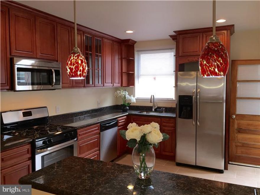 Looking for a gorgeous new large kitchen? Want a house that has been renovated and ready to move in, then this is the house for you! This house will delight you when you enter to see the large straight through that has been opened to the kitchen and new pendant lighting with a granite breakfast bar.  The inlay solid wood floors have been refinished to their original condition and the wood work from past workmanship, has been protected and kept in the house to also show the original design. A large livingroom  has a  mantel that would be a perfect spot for a flat screen television. The dining room has plenty of space for a large formal dining room set and perfect for family gatherings. Then...what a kitchen! Tall solid wood cherry wood cabinets, open shelf around the window above the kitchen sink, granite countertop and plenty of it! This kitchen has 7 drawers for the most organized cook! Stainless steel appliances, refrigerator, dishwasher, stove and hood microwave makes the kitchen complete, and even enough room for a bistro table. The breakfast bar and new pendant lighting helps with additional seating.  Work your way upstairs to the three good sized bedrooms all designer paint and ceiling fans. A cedar closet in the hallway will protect your clothes for the change of seasons.  The bathroom has custom tile work, separate shower stall, new tub, granite vanity top, new designer lighting - this bathroom is sparkling new waiting for the new owners.  The basement has been freshly sealed and painted and ready to finish.  Private parking in the back, and the garage is also perfect for more storage.  Make your appointment today!