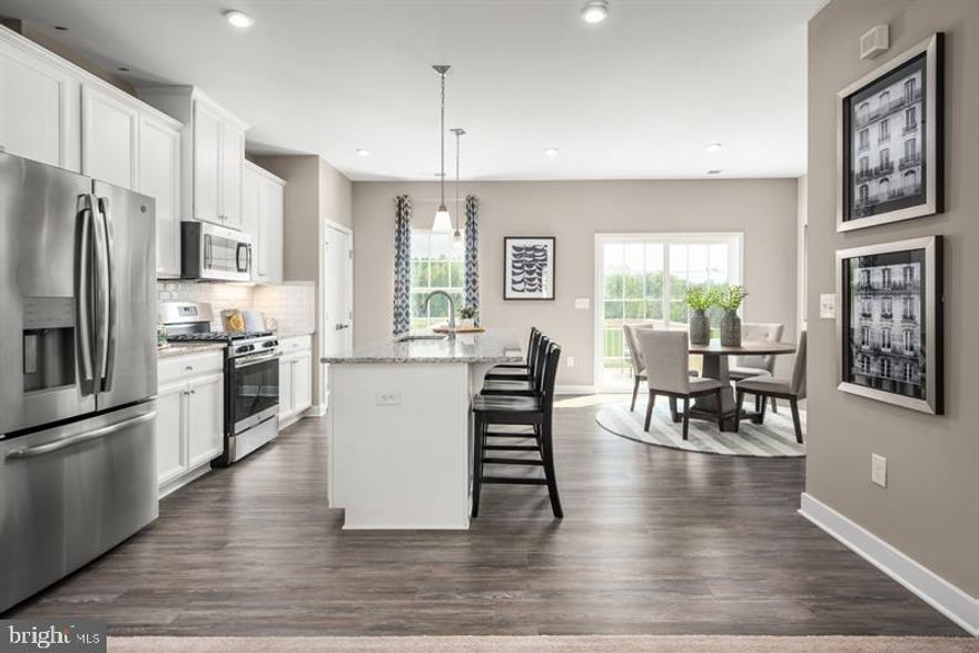 Welcome to the Mendelssohn, where the convenience of townhome living meets the amenities of a single family home. On the main living level, an enormous Country Kitchen with a large island opens onto a bright and airy Living Room, perfect for entertaining and featuring either a handy coat closet or a conveniently placed powder room. Upstairs are two spacious extra bedrooms with ample closet space and a hall bath, and a generous primary Bedroom that features an optional tray ceiling and a huge walk-in closet. A separate primary Bath features an optional dual vanity and optional oversized tub; or choose the opt. oversized shower. For a truly spa-like experience, select the Luxury primary Bath with separate soaking tub and shower. No matter what you choose, you'll still have a convenient 2nd floor laundry with room for side-by-side washer and dryer. Several lower level floor plans are available depending on community all feature options for a finished Recreation Room, Study, and Powder Room or Bath. Photos are representative. Lot Premium may apply.