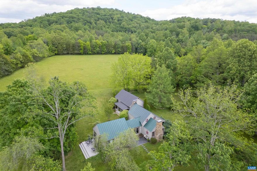 Carefully preserved and updated for comfort, this rare C. 1820 chestnut log cabin is move-in ready for full-time country living or weekend gatherings.  Nestled in the midst of 85 exquisitely private acres in Western Albemarle, the property offers several additional home site options.  The original living room with stone fireplace is the heart of the home. A bright kitchen addition features custom English style cabinets with hand cut stenciling, butcher block counter tops, stainless steel appliances, two generous pantries, an island and slate and pine floors.  Sliding doors open to a wide deck with room for entertaining. A second addition, completed in 2008, leads down a bright, tiled hallway to the primary suite which boasts a vaulted ceiling, cedar closet and red oak window trim and flooring. The entire tract features Blue Ridge views, stocked pond, woodland trails, rolling pastures, streams and vivid night skies.  Harris Mountain Farm is located just 15 mi from Charlottesville and the University of Virginia, 10 mi from the Charlottesville Albemarle airport,  5 mi from a 600 acre county park, and 18 mi from Shenandoah National Park.  The farm is also a short drive from numerous wineries, ski resorts, breweries and orchards.,Cherry Cabinets,Painted Cabinets,Wood Cabinets,Wood Counter,Fireplace in Bedroom,Fireplace in Living Room