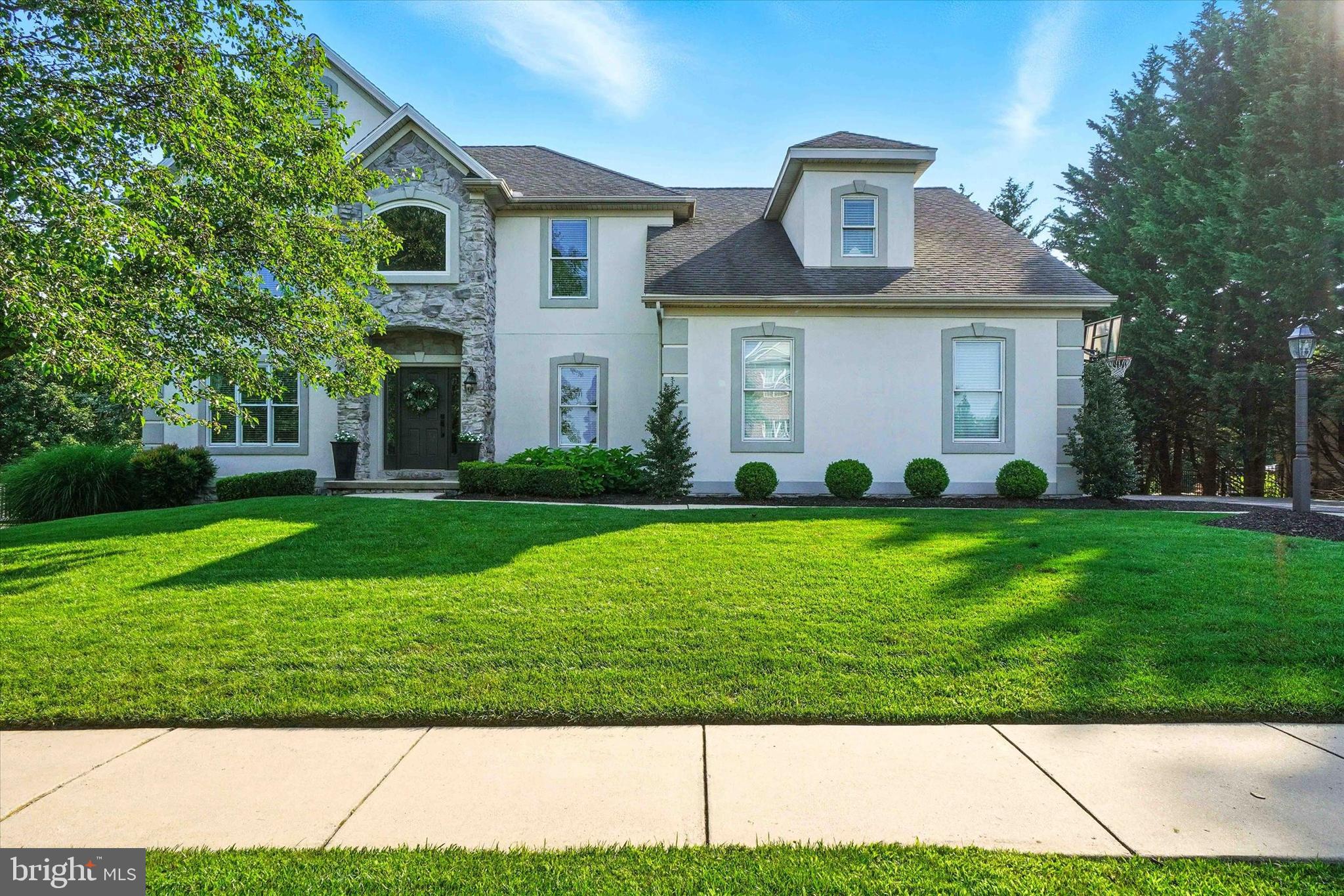 Exceptional 4BR, 3.5BA home in the sought-after Ridgefield Community—an exclusive enclave of distinguished homes just minutes to Apple Hill, WellSpan/York Hospital, York College, and I-83’s Leader Heights and Queen Street exits. Dallastown Schools! This meticulously maintained home combines modern design with timeless elegance, offering both grand scale and everyday comfort. A 2-story entry foyer welcomes you into the home showcasing 9’ ceilings, gleaming hardwood floors, and refined architectural details throughout. A living room flows seamlessly into the dining room with tray ceiling and decorative moldings. The light-filled gourmet kitchen is a chef’s dream, complete with granite countertops, a center island, pantry, and stainless steel appliances. The dramatic 2-story family room showcases a beautiful new floor-to-ceiling stone fireplace, perfect for cozy evenings and sophisticated entertaining. A 1st floor office/bonus room provides a quiet, dedicated workspace for remote work or whatever other space you might need. Upstairs, the private primary suite features a custom walk-in closet, with built-in organizers; and a spa-like bath with dual vanities, whirlpool tub, and a separate shower. There are also two generously sized bedrooms joined by a Jack & Jill bath, featuring dual vanity areas connecting the tub/shower/toilet area. One of the bedrooms has a large walk-in closet with built-in organizers. A 4th bedroom suite has a private full bath. The 2nd floor also features a convenient laundry room. The expansive lower level offers a versatile finished family/game room with a second kitchen—ideal for entertaining or extended-stay guests. It has walk-out access to the serene backyard. Additionally there is ample partially finished space for future expansion, including a room ready for a full bath. This home offers a spacious deck with views of a lush backyard and generous storage rooms beneath for tools, equipment, or seasonal items. It’s perfect for extended outdoor living and entertaining. The oversized 3-car side-load garage provides functionality without compromising curb appeal. Truly, this exceptional property offers the perfect blend of privacy, convenience, and luxury living in one of York County’s most desirable neighborhoods. Newer HVAC (2023) and Dual Water Heaters (2021). NO Association or Fees! AGENTS - Please read Agent Remarks.
