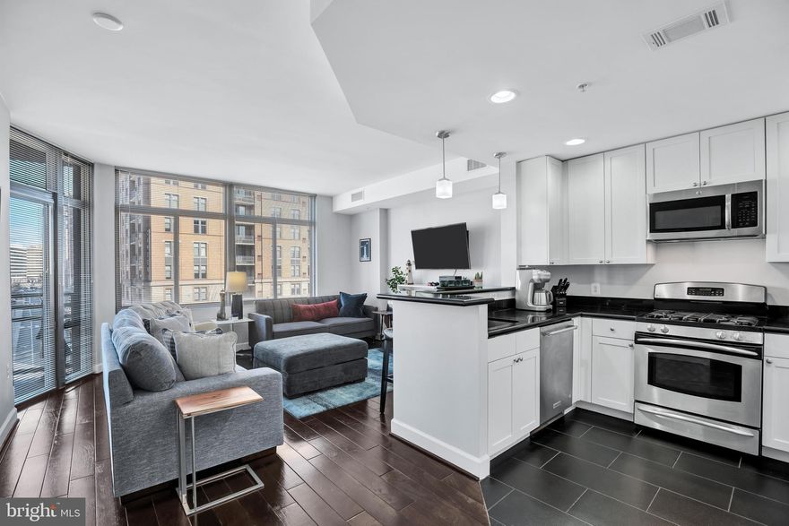 Discover the perfect blend of style and comfort in this updated 1-bedroom, 1-bath condo at The Eclipse. Bathed in natural light from floor-to-ceiling windows, this sophisticated residence features rich chocolate brown hardwood floors and an airy open-concept design.

The impeccably appointed kitchen boasts stainless steel appliances, white cabinetry, ample storage, and recessed lighting. It seamlessly flows into the spacious living area, creating an inviting and relaxing space. Step onto your private balcony to enjoy city views.

The generously sized bedroom offers a custom walk-in closet, while the updated bathroom showcases a sleek walk-in shower, white cabinetry, and stylish black accents. Additional conveniences include an in-unit washer and dryer, a dedicated garage parking space, and a storage unit.

The Eclipse provides an array of premium amenities, including a 24-hour concierge, fitness center, swimming pool, party room, and a breathtaking rooftop terrace with panoramic views of the Potomac River and Washington, D.C. Plus, enjoy the ultimate convenience of having a Harris Teeter grocery store just moments away.

Ideally situated for effortless commuting, this prime location is just minutes from the new Potomac Yard Metro, Crystal City, and Pentagon City Metro stations and Metrobus stops. Reagan National Airport, Amazon HQ2, and the vibrant dining and shopping of Crystal City, Pentagon City, Del Ray, and Old Town Alexandria are all within easy reach. Outdoor enthusiasts will love the nearby scenic trails and green spaces.

This thoughtfully designed floor plan includes a versatile nook—perfect for a home office, meditation space, or cozy workout area.

Modern, stylish, and exceptionally well-connected—experience the best of urban living at The Eclipse.