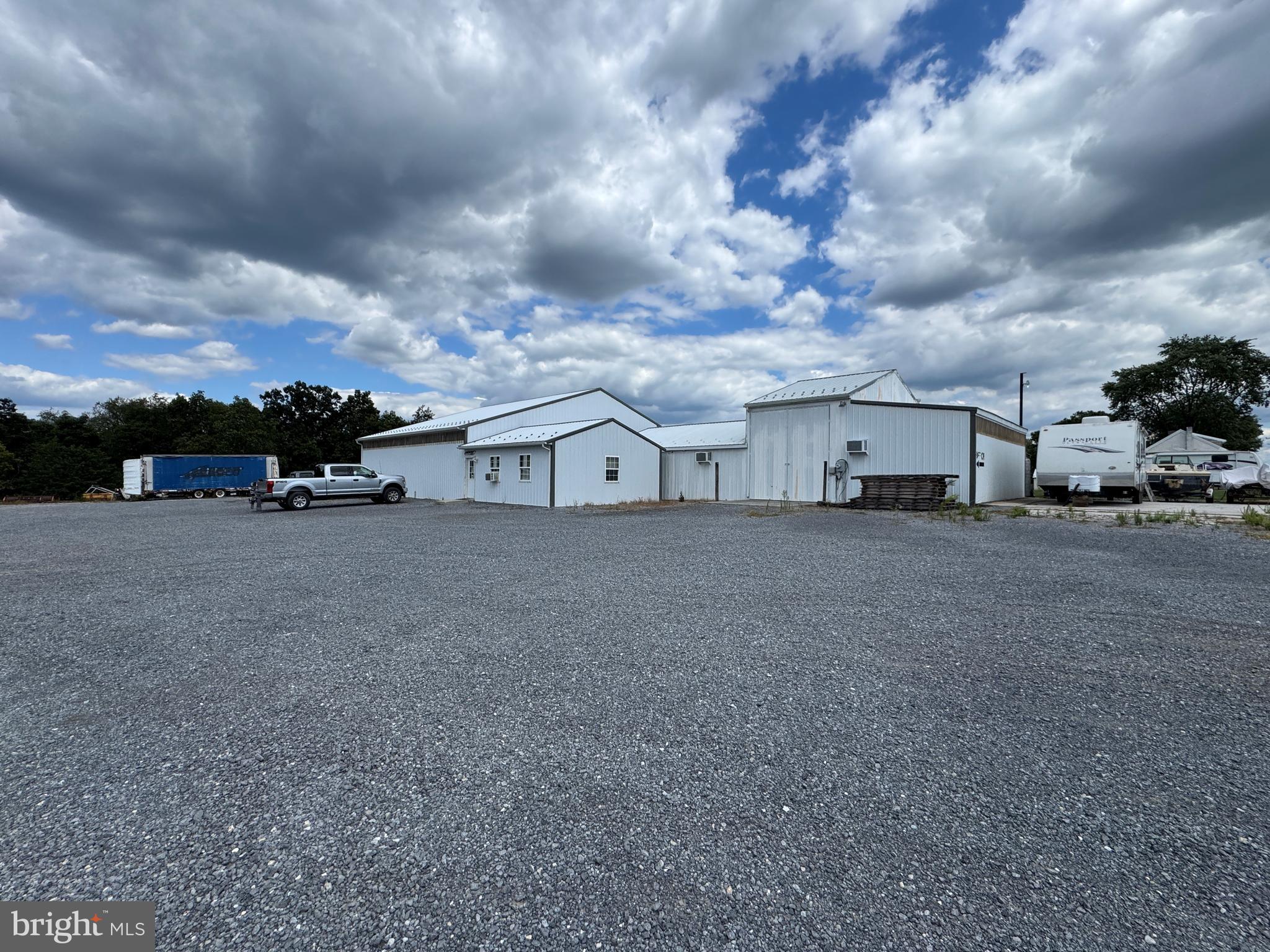COMMERCIAL BUILDING WITH A HOME ON 7.3± ACRES This exceptional property combines peaceful residential living with extensive commercial space, offering outstanding potential for a wide range of uses. The home includes three bedrooms, two full bathrooms, a kitchen, dining room, living room, mudroom, and basement. The commercial building encompasses approximately 5,757 square feet and features two clear-span shops measuring 48' x 53' and 36' x 65'. Access is provided by three large doors, including a 17.5' x 16' double sliding door, a 12' x 12' set of barn doors, and a 10' x 12' overhead door with power opener, along with five man doors. The building is equipped with a 5-ton overhead bridge crane (3-phase) and three jib cranes, making it well-suited for heavy-duty operations. An office area includes a reception space with a large supply closet, three private offices, and built-in desk and cabinetry. Additional features include a 25 HP power inverter, propane heat with three units rated at 200,000, 100,000, and 75,000 BTUs, and air conditioning provided by four 25,000 BTU window units. The property also offers a large Daytona air compressor with four hose reels (10 HP, 3-phase) and a 16' x 40' insulated, heated, and cooled paint booth. Situated in a peaceful country location and previously used as a welding shop, this property offers excellent versatility for all types of uses! This property will be offered at auction on Wednesday, October 8, 2025, at 3:00 PM. The List price in no way represents a minimum, starting, or acceptable bid.
