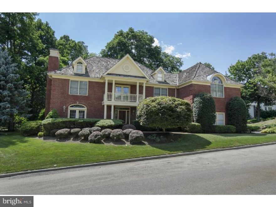 Stately brick colonial offers handsome and classic exterior with open bright interior floor plan on its finished three levels. Two story foyer is highlighted with gleaming marble floors, sweeping open staircase and classic open center foyer plan. To the left through wide cased opening is the formal living room with eastern facing windows, gas burning fireplace and French doors to the library/office. To the right of foyer find an elegant dining room with paneled wainscoting French doors to the front of the home and service door to the kitchen. Straight off of foyer enter a dramatic two story family room with full wall of windows and French doors to the rear terrace and flat rear yard. This light filled space offers gas burning fireplace with faux block limestone finish. Wet bar with glass display shelving and storage cabinets. Privacy door opens from the family room to the library office which is detailed with a deep window seat, coiffured ceiling and custom shelving. This space functions as an ideal work or quiet retreat space. Gleaming all white chefs kitchen offers beautiful and highly functional preparation space with cashmere granite counters, wall, baking ovens, microwave, seated granite island gas cooktop and deep sink under oversized window which enjoys views of the rear yard. Steps away is a vaulted breakfast room with wrap around windows and door to rear terrace. Mudroom/laundry room and ample closets connect to the homes three car garage. Two powder rooms complete this level. Ascend the sweeping stairs to the two story overlook with views of both the formal foyer as well as the family room. Double doors lead to a deluxe master suite with sitting room, large bedroom with coiffured ceiling and his and her closets. Neutrally tiled marble bath offers jetted upper window tub, seated marble shower, separate vanities, hers with a seated makeup area and private water closet. Three additional bedrooms, two with vaulted ceilings and skylights, and all with private baths and generous closet space.  Bright, balanced and in move-in-condition.