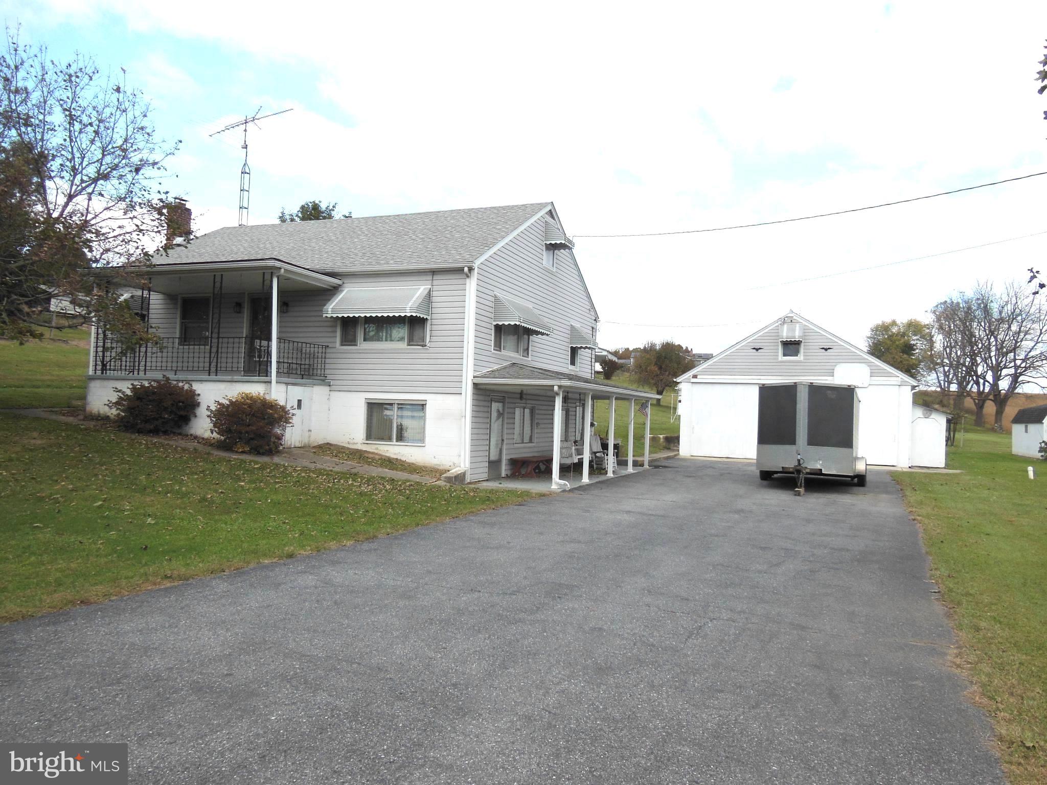 Great opportunity to own this raised rancher on 1.68 acres near Libertytown. Possibilities galore to make this into your dream home. Main upper level features full kitchen with abundant rich wood cabinetry & adjoining dining area, with walkouts to front porch with steps & side yard. Gleaming hardwood floors accent the living room, 2 bedrooms & office/den. Full bath with tub-size step-in shower as well. Walk up stairs to large fully floored attic with space for possible additional living area. Lower level features entry from driveway & walk-up stairs to main living area. Includes large family/rec room, full summer/canning kitchen with table space, washer & dryer, utility room & half bath. Estimated approx 2,000 finished square ft. Outside is asphalt driveway & 24'x36' garage/shop with 2 sliding doors, electric, concrete floor. Includes large overhead storage area/loft & chimney. There is also a 11'x24' garage/shed with overhard door & a 9'x14' shed. Asphalt shingle roof on house approximately 5 years old. Septic was upgraded in summer of 2023. This property is an estate & sold STRICTLY AS-IS!!