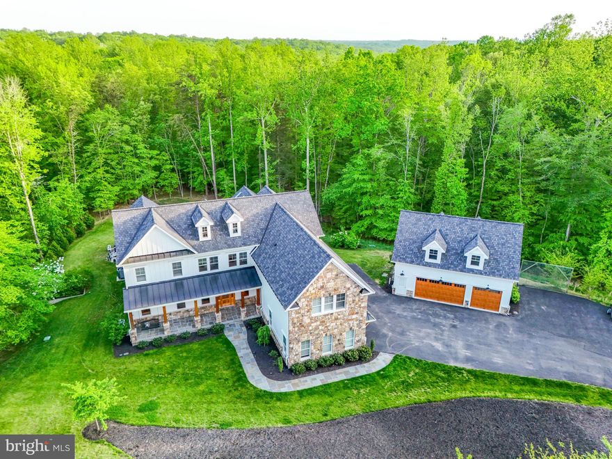 Welcome to Lawter Lane, where comfort meets class in this dazzling abode! This 5-bedroom, 6.5 bathroom masterpiece sprawls across a generous 5,2 acre lot, offering a serene oasis nestled amidst acres of privacy and trees. Step inside and be greeted by a grandeur that screams "entertainer's dream." The main floor boasts a primary suite that whispers luxury, while an elevator discreetly connects all levels for seamless access. The gourmet kitchen is a culinary artist's delight, ready to host any soirée you can envision. A separate dining room offers views to the outdoor living and the side yard while you can sit comfortably at the perch of deck looking out over the treed lot or the edge of the pool and enjoy a quiet moment or company in your living room. And for those who cherish the great outdoors, this home doesn’t disappoint. Slide open the fully retractable sliders to reveal a sparkling pool in the courtyard, complete with an outdoor covered living area that invites alfresco dining. As the sun sets, gather around the built-in fire pit and soak in the tranquility of your private wooded retreat. Convenience abounds with a laundry room on each level—because who says laundry can’t be luxurious? And for the car enthusiast, a 6-car garage awaits, with an apartment perched above the detached garage, perfect for guests or a creative studio. This home has space for recreation, health/ yoga and exercise, play rooms and more!  With its blend of sophistication and functionality, this property isn't just a home—it's a lifestyle. Come see why 11607 Lawter Lane should be your next address!