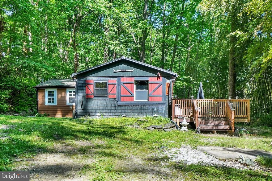 Secluded property on almost 1 acre near fishing streams! Come check out this beautifully restored 2-bedroom, 1-bath home tucked away in a peaceful setting. From the moment you pull up the driveway, you’ll be captivated by the charm and character this unique property has to offer.

The exterior features eye-catching cedar shake siding, a goldfish pond, two fire pit areas, and an oversized front porch that’s perfect for BBQs, entertaining friends, or simply relaxing outdoors.

Step inside to a welcoming kitchen featuring a deep farmhouse sink, and a countertop dining area with seating for two at the window overlooking the cozy living room. The living room offers vaulted ceilings and a wood-burning stove, creating the perfect space to relax and unwind year-round.
The light and airy primary bedroom features sliding glass doors leading to a private second porch area, providing a peaceful retreat to enjoy your morning coffee or evening sunsets.
Recent updates include an updated bathroom, updated plumbing in the kitchen and bath, a metal roof that is only a few years old, and the addition of a generator for added peace of mind.
This home is truly an entertainer’s dream, offering the perfect setting to gather around the fire under the stars during warmer months or cozy up inside during the winter and let your worries melt away.
Home comes fully furnished. Schedule your private showing today! More photos to come on 5/20
