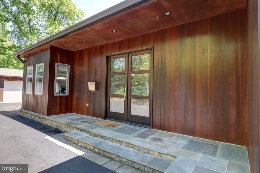 Gorgeous, private estate in the heart of North Arlington, minutes to Mclean.  Spacious 4,000+ sq. ft., two-level architectural gem, with open concept living, coveted vaulted ceiling kitchen, large custom windows and lots of off-street parking, making it a perfect home for gathering with family and friends. Completely rebuilt, detached 4+ car garage with new doors.  Southward-facing house gets tons of natural light creating a cheerful space. Luxury, high-end custom finishes.  Walnut double wide front doors open into a sunny foyer.  Sunny study on your left. Ground floor Master Bedroom, with spa shower.  Second bedroom with full bathroom.  Spacious yet cozy open living room with gas fireplace.  Three entryway accessible dining room, Chef’s kitchen, modern kitchen breakfast nook, adjoining the huge covered mahogany deck overlooking 17,239 sq ft. (.4 acres) of secluded property.  Private large fenced-in back yard.  Custom glass-paneled staircase leads to the 2,000sf downstairs living area, with an au pair room with en suite full bathroom and walk-in closet.  Spacious game room that easily accommodates a large billiards table, an adjoining large media room and space idea for a walk-up wet bar.  Workout room which conveys with a gym quality NordicTrac treadmill, Precor recumbent bike, ceiling fan and wall-mounted TV.  Oversized laundry room with custom cabinetry.  American Standard HVAC in well-maintained excellent condition, only four years old.  Separate storage room with room to spare, ideal for use as a wine cellar.  Backup Honeywell Generator to power the entire house, with a separate natural gas energy source, so you never lose power.  Hard wood floors, custom porcelain tiles, brushed nickel Schön and Danze fixtures, Kovac lighting, Kohler sinks & toiletry.  1,000+sf attic storage space.  Quiet location at the crest of a hill above neighboring homes, directly across the street from Jamestown Elementary open fields and green space.  Well inside the beltway, just minutes to Chain Bridge, Kennedy Center, walking-biking trail network, George-Washington Parkway, Key Bridge, Tysons Corner.  12 min. commute to Pentagon or Georgetown.