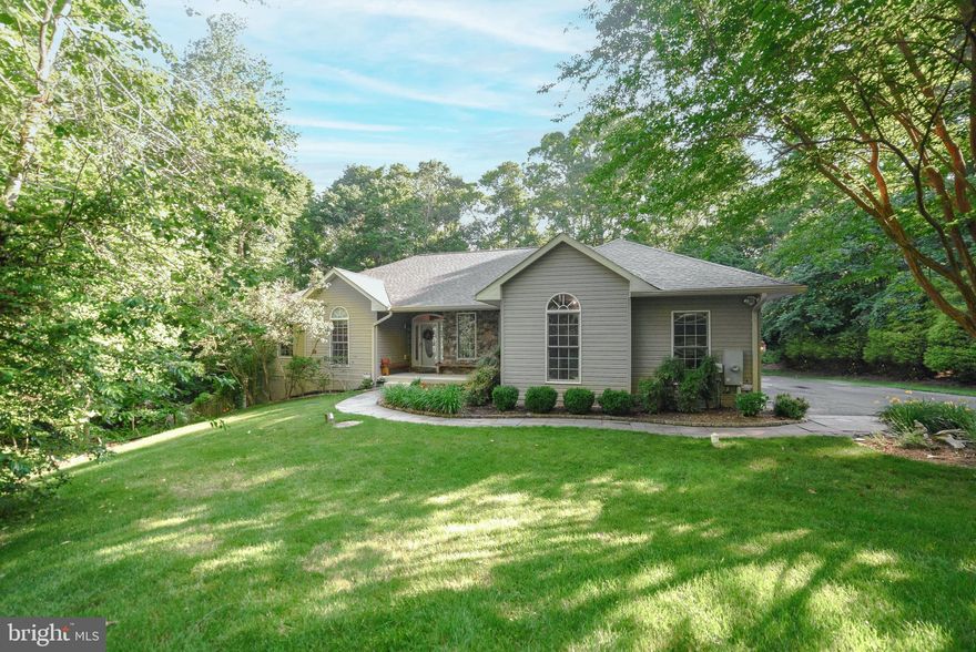 Custom-built rambler on a very private 15-acre lot. Popular open floor plan with beautiful hardwood floors throughout, separate Dining Room and a Great Room w/wood burning stove. The kitchen features a new induction cooktop on a gorgeous island: hickory cabinets, a Butler Pantry, two wall ovens and a Wet Bar with a built-in wine cooler. Too many features to list: Four Bedrooms, 3.5 Baths, fenced yard, patio, three-car garage, laundry, partial finished huge basement with two safe rooms. The beautiful Master Bath was recently completely remodeled with a huge double shower and double vanity.  Gorgeous front yard with great landscaping with built-in french drains and dry wells for drainage. Check out the trail to the hidden overlook deck through the woods! New roof 2022, new GeoThermal system installed in 2014. There is a neighborhood HOA but no covenants and restrictions for the four properties on this lane.