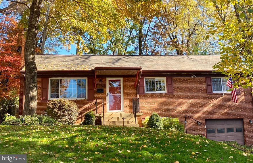 This gorgeous 3 bedroom, 2 bathroom home has been updated throughout but retains its vintage charm with original hardwood floors and cozy fireplace. The light and bright updated kitchen opens to the great room, complete with vaulted ceilings and exposed brick, and overlooks the stone patio and manicured lawn. The renovated basement includes an optional fourth bedroom or office. The meticulous garage has ample storage and workshop space – and plenty of room for your gear!   Many upgrades have been completed throughout this home. Notable upgrades include the full basement remodel in 2016 including full bathroom renovation, custom tile flooring, new carpet, and all new plumbing throughout. Main level full bathroom remodel includes marble tile and custom vanity. Kitchen remodel in 2020 complete with quartz countertops, new stainless-steel fixtures, and new appliances. The great room features a fully custom built-in entertainment center, perfect for movie night! Enjoy outdoor living and entertaining with the custom hardscaped stone patio, ambiance lighting, and lovely landscaping. New roof 2019, new water heater in 2019, and smart home features include an ecobee thermostat. Fresh paint and gleaming refinished hardwood floors throughout. This home is authentic and charming, with modern amenities and classic details.  The home is located in Broyhill Crest - surrounded by parks, neighborhood pool, tennis courts, walking trails.   And, a great commuter location - inside the beltway.