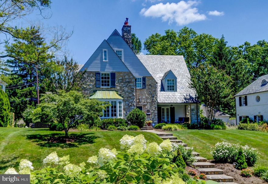 Beautiful Homeland stone and stucco porch front Colonial with five bedrooms, four full and two half baths, beautifully updated with a two car garage. Gorgeous hardwood floors, french doors, and fine millwork grace the interior of this traditional home. The spacious and updated Chef's kitchen features a gas cooktop, high end appliances, island and is open to a breakfast area. Perfect for entertaining dining room with built-in China cabinets and french doors to patio. Cozy family room and a sun filled living room with gas fireplace. The upper levels include a wonderful master suite and four more bedrooms and updated bathrooms. A wonderful finished lower level completes this beautiful home!