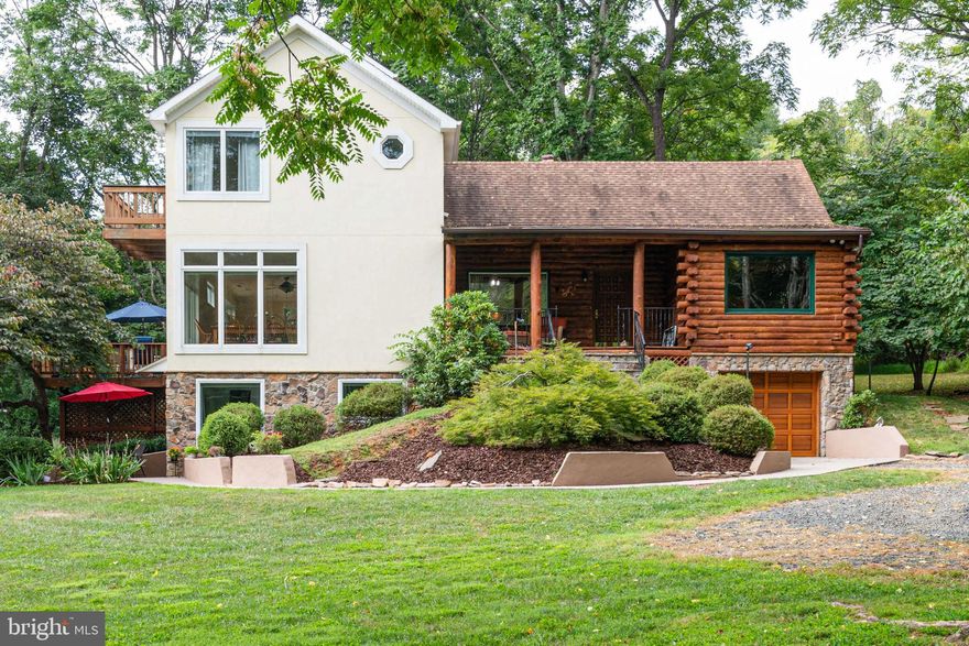 Beautiful 5 wooded acres with stream, very private, original log home with huge addition and in-laws/au-pair suite in basement.  The log part of the home boasts a gorgeous stone fireplace that spans the first and second floors, follow the winding staircase up to one of the second floor bedrooms. The warm and cozy  kitchen is to the left of the foyer when you first walk in, it has a huge walk-in pantry and a breakfast bar.  The Great Room is right off the kitchen and has a large dining area to accommodate plenty of guests, it also features floor to ceiling windows and french doors that lead out to a large deck that overlooks the side yard and woods- a great place to entertain family and friends or for quiet evenings to listen to the sounds of nature and watch all the wildlife. The large upstairs owners suite has a balcony overlooking the property, a gorgeous tile and granite bathroom with soaking tub and laundry area just outside the bedroom. The basement area has a third bedroom and full bath with a kitchen that can accomodate a range and small refrigerator. It has a washer/dryer hook- up for separate laundry,  zoned separately for heat and a/c and a cute stone patio outside the private entrance; could easily be made into an in-laws suite or a rental opportunity. The property has peach and apple trees and plenty of room for vegetable, herb or flower gardens and a large shed to accommodate the mower and tools. Attached garage is very deep for one car and plenty of storage or work shop.  Brand new  carpet throughout, washer and dryer about a year old, refrigerator about 3 yrs old, water softener added in 2019, new pressure tank 2019, hot water heater new. Minutes from the town of Marshall and Rt 66. THIS IS A GEM YOU DON'T WANT TO MISS!