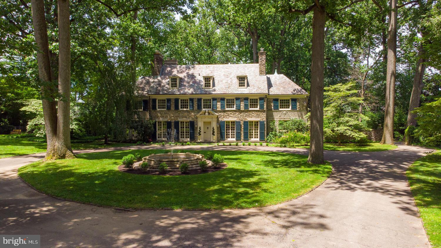 Rare is the experience and opportunity in life where Beauty, Nature, Architecture, Provenance, Value, and just plain FUN coalesce in such a wonderful moment...Presenting Fox Muir of Elkins Park! Exceeding today's standards in every delightful way, this classically designed and expertly constructed 1928 Colonial Revival Masterpiece, by one of Philadelphia's most prestigious Architects, Robert Rodes McGoodwin (also famed for Chestnut Hill's 'French Village'); stands proudly today- timelessly built for the ages. Carpe Diem! As this is now 'your' moment to own it... Greeted by the impressive scrollwork of the original wrought-iron gate, the elegant, private drive extends onward to 3.2 harmonious acres. The centerpiece limestone fountain of the circular drive playfully announces what further delights await... Seldom can one state 'improved upon,' without a slight cringe- as usually the original was perfect, and yet... owners to date have respectfully added SUCH remarkable features to this home- that they literally wrote a book about it! The livable interior warmly embraces with its gentle tones and ornately friendly Egg & Dart w/ Greek Key moldings and mantels; juxtaposed with impressive Corinthian columns standing at attention in the Center Hall. Grounded by richly honey-hued old growth Oak, and crowned with a Venetian glass Chandelier, the formal Dining Room is graced by a handpainted bucolic scene by J. Frank Copeland- which seamlessly extends the Artist's vision through the double French Doors beyond to the beautifully landscaped intentional natural setting of Fox Muir. Beyond is an expansive Eat-in Chef's Kitchen w/ custom-made leather banquet; and direct access to Butler's Pantry, back staircase, stone Mudroom, and attached triple-bayed Garage Alcove. Additional first level living offers a slate floored Day Room/ Family Room w/ pressed tin ceilings and views of the gardens; a brick-paved linear Solarium with rear views of the sculpted back Patio w/ circular 'mini-pond.' Mais la piece de resistance quietly beckons with Sacred dignity: 'the Den.' Literally, the hand-carved elements of an Episcopal Church Chapel were lovingly saved then reconfigured to bring 'Peace' to all who enter this space. A large wood-burning fireplace, ornate ceilings, and paneled walls may bring focus- yet the organic outdoor views to additional Garden Rooms and Fountains subtly compete for attention as well. Now that your 'prayers have been answered...,' it's time to celebrate in the Home's lower level w/ its very own 'Speak Easy.' Yup! An authentic Elk's Club, imported from the 'burning' town of Centralia- now beckons below with a steamy full bar, lounge, and a movie theatre. Retractable curtains frame the large screen, replete w/ a brand new state-of-the-art Sony 4K projector, built-in THX surround system, and elevated stadium seating w/ luxury leather reclining seats complete. The adjacent Arcade (in the large Utility Room) may not be an Inclusion...but it sure might inspire the start of a new collection. On the subject of revelry, this amazing property boasts a salt-water, heated swimming pool w/ full and architecturally significant Pool House; a Tennis/ Basketball Court, and a newly added 'Superior Play System Extreme Combo-' basically, a playset for kids ages 2 to 90+...The elegant sightlines of the gracious Home are still protected (from the romping) as an expansive backyard of towering and historic Tulip Poplars canopy this private world- all surrounded by a handsome security fencing installed by the present owner. Returning to the second and third interior levels of of this wonderful Home- many options for multi-generational living or a house full of guests with several wings, 7 Bedrooms, and 6.2 Baths to serve. Special attention must be paid to the amazing wall tilework in the Master hosting an elevated fireplace, as well as the original Art tiles of several Baths. Words just aren't enough...come, see, and experience.