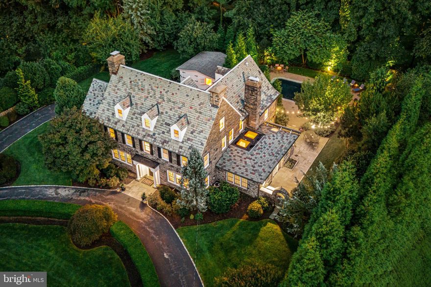 Welcome to this simply spectacular, stone Main Line residence with pool and pool house,  majestically set on a private, breathtakingly landscaped lot in the highly coveted, walkable "Merion Cricket" neighborhood, in prestigious North-side Haverford. Rarely does a property like this become available, within a short walking distance to trains, clubs, renowned public and private schools, endless shopping, fabulous restaurants and more. Beautifully renovated and updated throughout, this sun-filled, gracious center hall home offers generously proportioned, bright rooms with an easy open flow, original restored floors, millwork, moldings and 1920's architectural details, perfect for comfortable everyday living and effortless entertaining on an intimate or larger scale. Endless features include an inviting living room with fireplace, spacious dining room, expansive sunroom/ office with wet bar and wine refrigerator, newly renovated white gourmet kitchen with custom cabinetry, natural marble countertops and Thermador chef's appliances opening up to a sunny breakfast room with French doors, family room with fireplace, exterior terraces with serene views, convenient mudroom and rear staircase leading up to the second floor. The  original grand staircase flows openly from the foyer to 2nd and 3rd floor landings. Upper level amenities include a 2nd floor luxurious primary suite with expansive walk-in closet/ dressing room, timeless tumbled marble bathroom, two vanities an oversized frameless glass shower and radiant heated floors, 4 additional second floor bedrooms with 2 additional updated full neutral-tiled baths, third floor with a 6th bedroom  with en-suite renovated bathroom, two additional large, bright bedrooms and an updated full hall bathroom. The walk-up lower level offers a finished game room with wet bar, stone fireplace, large laundry room, lots of dry storage and easy access to the 3 garage spaces and rear grounds. The fabulous pool, colorful flower and herb gardens, extensive hardscaping, charming pool house with changing room and full bathroom complete this incredible property!