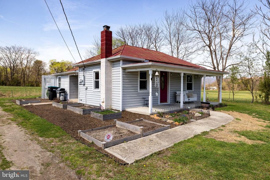 This adorable 2-bedroom, 2-bath bungalow is in excellent condition and full of thoughtful updates! Located just outside the town limits of Stanley, this home offers a spacious open yard with beautiful mountain views—perfect for peaceful country living. Lovingly maintained, the home features fresh interior paint, a new UV water filtration system (2023), hot water heater (2019), all-new light fixtures (2025), updated shower heads and faucets, and refinished hardwood floors. The living room includes newly built custom shelving that provides ample storage while doubling as a unique built-in kennel for two large dogs, complete with a small electric fireplace for added warmth and a dedicated space for food and water bowls—perfect for pet lovers! Outside, enjoy raised herb beds, a generous yard, and a charming front porch, ideal for relaxing with your morning coffee while taking in the scenic surroundings. This home offers the perfect blend of comfort, functionality, and charm in a serene setting.