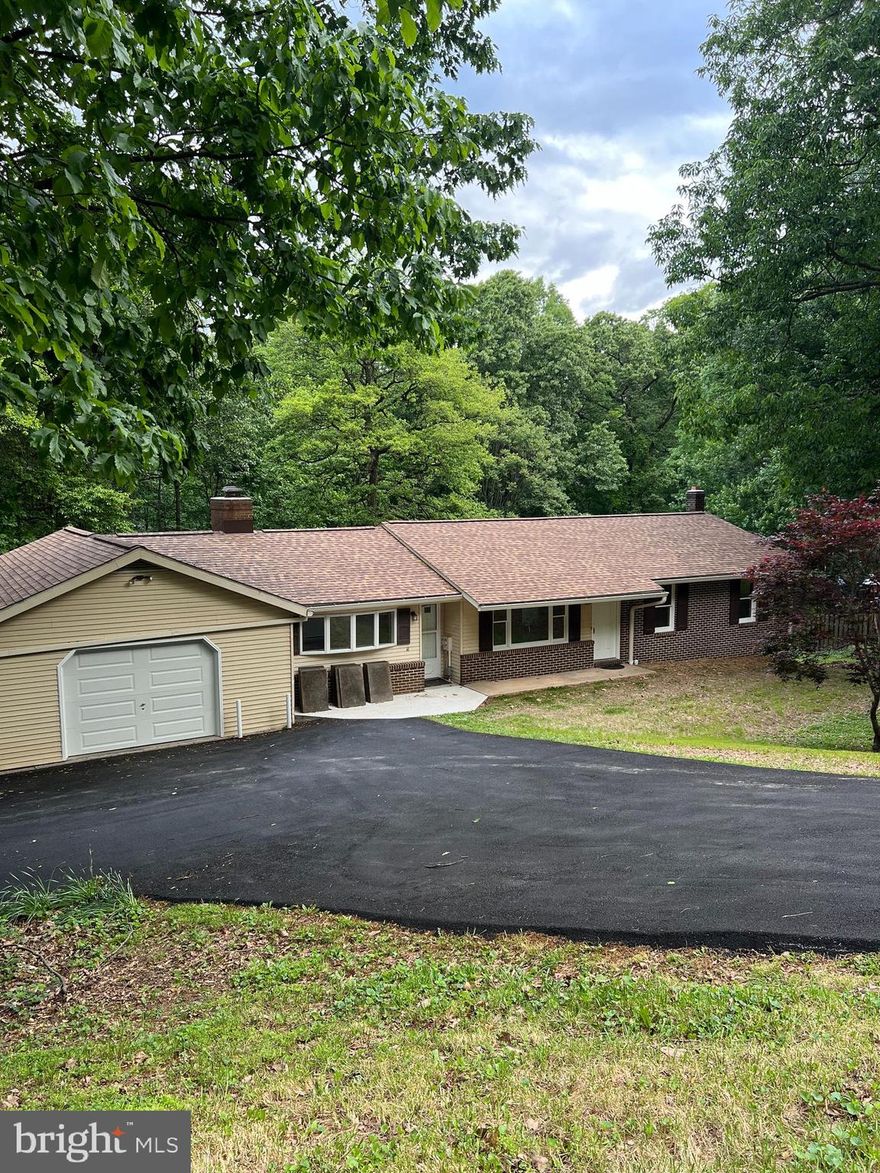 New, New, New – Over $100,000 in upgrades for this 3Br, 2Ba, 2,888 total sq. ft., home on a gorgeous 1.4+ acre lot in the sought-after, quiet, Mill Bottom neighborhood in the charming town of Mt. Airy, MD.  This home is perfect for those who enjoy primary floor living.  Loads of natural light fill the rooms provided by large windows, new  skylights, and patio doors.  Gather for family living in the great room, brightened with skylights, bow windows, glass patio double-doors, soaring ceilings, and fireplace.  Polished hardwood floors shine throughout first floor.  Entrance through living room or Great Room.  All new kitchen with gorgeous quartz countertops, and stainless appliances.  Experience breakfast looking out over nature through sparkling glass doors.  Renovated full baths accentuated with modern lightening.  Enjoy entertaining your friends on the fabulous back deck that runs across the length of the house overlooking a huge, green, lush backyard that backs up to wooded privacy.  Cozy-up for movie night in front of the wood burning stove in the finished, walk-out lower level.  Set-up a large private office, study, or playroom in the additional room in the basement. Spacious laundry room with brand new washer and dryer. Utility room includes new water heater and pressure tank.  Additional bonuses to this home include a cedar closet, brand-new roof, chimney crowns, and gutters, as well as a new well-pump, and new heat pump/air conditioning.  Get creative in the oversized garage perfect for adding your own workshop. Turn-around driveway with room for multiple vehicles including a parking pad at the top of the driveway.  Easy access to Baltimore and Washington DC, located along the I-70 Corridor connecting Frederick, Carrol, Howard, and Montgomery Counties.  Minutes to historic, downtown, Mt. Airy and plentiful shopping and restaurants.