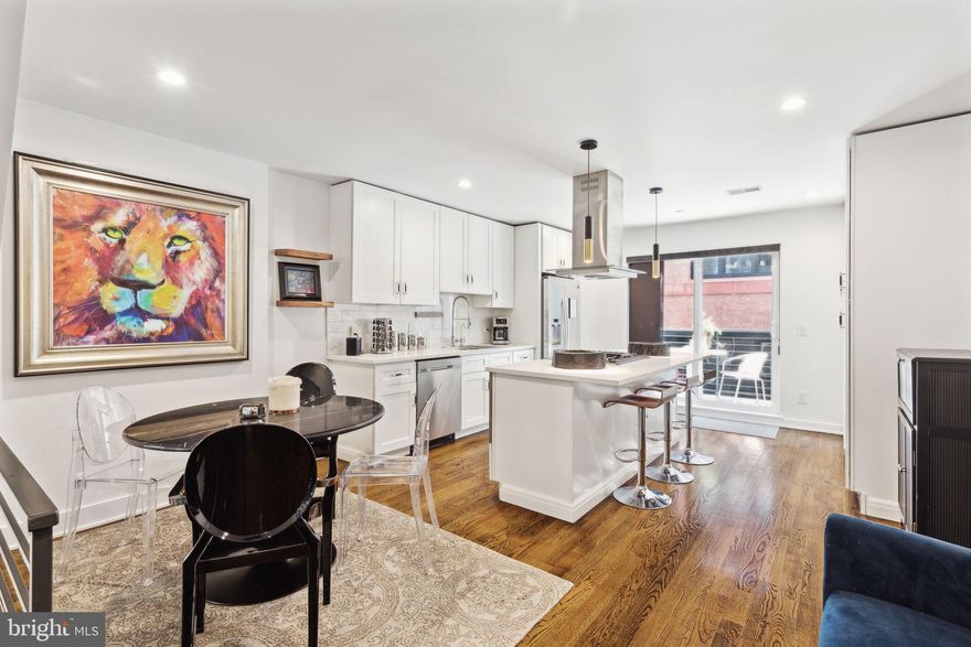 Welcome to 1506 N Philip Street - a RARELY OFFERD FULLY FURNISHED TOWNHOME WITH PARKING!  This gorgeous property is nestled on a quaint, tree-lined street near Hancock Park, and just steps from favorite spots like New Liberty Distilling, Punch Buggy Brewing, Reanimator Coffee, a variety of gyms, and the vibrant Frankford Ave. dining scene featuring Laser Wolf, Suraya, Kalaya, Mulherin’s, La Colombe, and more.
Step inside to an open concept living room with impressive 16' ceilings, massive windows that flood the space with natural light, and elegant hardwood flooring. Custom blinds adorn all of the large windows. Beyond the living room, find a convenient half bathroom and an oversized garage with room for one car and extra storage, accessible through a secure gated driveway. The first floor also provides access to a finished basement, featuring 11' ceilings, a full bathroom with standup shower, closet space, and plenty of options to use this space as a home gym, guest room, and also home office.
Upstairs, the kitchen and dining area overlook the first floor and are a chef's dream, boasting quartz countertops, stainless steel appliances, a large island, upgraded storage, and ample counter space. Sliding glass doors off the kitchen lead to a deck, perfect for morning coffee or outdoor dining  Further upstairs, find two spacious bedrooms, a full bathroom in the hallway, and a stacked washer and dryer.
The third floor features the luxurious primary suite with three large closets, including one oversized walk-in, and a sprawling, spa-like bathroom with a freestanding soaking tub, massive shower, dual vanities, and linen closet. A wet bar with a built-in refrigerator and coffee station is located in the hallway. The brand-new upgraded roof deck is perfect for entertaining, offering stunning views of the skyline and the Ben Franklin Bridge.
This stunning home is available for short and long term leasing!