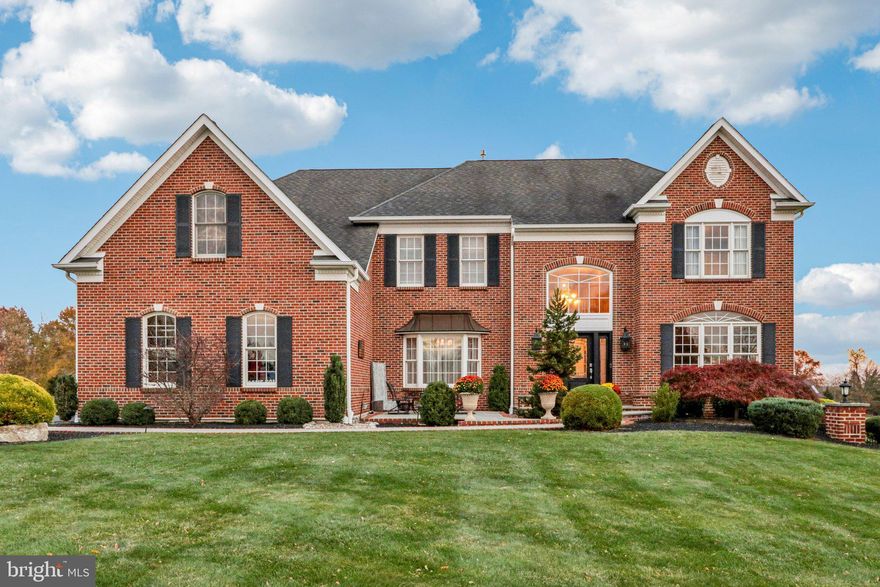 Welcome to 433 Elizabeth Way.  This distinguished brick colonial residence is located in Hatfield’s premier community, The Reserve at Hilltown. This home offers over 5,700 square feet of refined living space on a beautifully landscaped three-quarter acre lot. Exceptional space inside the home is equaled by the outdoor living spaces including the must see deck. 

The approach to the home is warm and inviting, featuring a front blue stone patio with a fire pit that is perfect for evening gatherings under the stars. Inside, a grand two-story foyer with an elegant staircase and gleaming hardwood floors sets the tone for the rest of the home.

To the left, a spacious formal dining room provides the perfect setting for entertaining. The gourmet kitchen is both stylish and functional, featuring 42-inch off-white wood cabinetry, granite countertops, stainless steel appliances including a built-in oven and separate gas cooktop, and a generous center island with seating. The kitchen flows effortlessly into the sun-filled family room, highlighted by a vaulted ceiling, dramatic floor-to-ceiling windows, and a beautiful stone gas fireplace that creates a warm and welcoming atmosphere.

A private office on the main level offers a peaceful workspace, while the breakfast nook opens to a large multi-tiered Trex deck overlooking the expansive fenced backyard, ideal for outdoor dining or gatherings. The property also includes a three-car attached garage for convenience and a backyard shed providing additional storage space.

Upstairs, the primary suite is a serene retreat featuring high ceilings, recessed lighting, a comfortable sitting area, and two walk-in closets. The spa-inspired en suite bath includes a built-in soaking tub, glass enclosed shower, and dual vanities. Three additional bedrooms include one with a private full bath and two that share a beautifully designed Jack and Jill bathroom.

The finished walk-out lower level adds approximately 1,753 square feet of exceptional living and entertaining space. Enjoy a custom-built bar with a stone archway, granite countertops and built-in refrigerator. A dedicated movie theater room with surround sound creates an immersive cinematic experience, while additional areas provide space for a playroom, recreation area, or fitness room. An unfinished section offers abundant storage or the potential for a home office or hobby room.

Newer Hardie board siding has been installed on the exterior walls and the air conditioner compressors have been recently replaced. Meticulously maintained and thoughtfully designed, this home offers sophistication, comfort, and convenience in one of Hatfield’s most desirable neighborhoods. Schedule your private showing today and experience the elegance of this remarkable property.