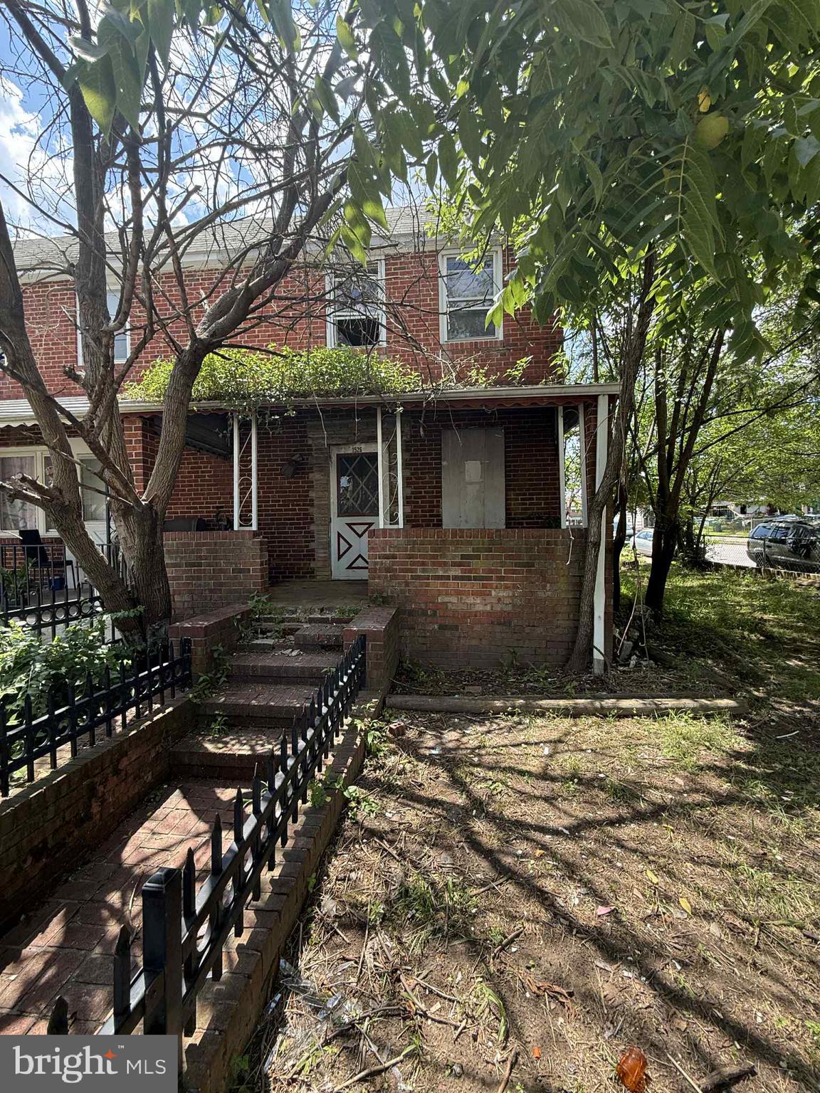 Fantastic investment opportunity in this end of group townhome to either fix up and sell or rent out! There is a large front, back and side yard with so much space plus a shed off the back alley, and a large, covered patio and front porch. Upstairs there are 3 bedrooms and 1 full bathroom, exposed brick in the living room, and a large basement with a walkout exit. This home does need work but there is so much potential just waiting for your vision. Being sold strictly as-is, seller will not make any repairs. Buyer to verify ground rent information is correct.