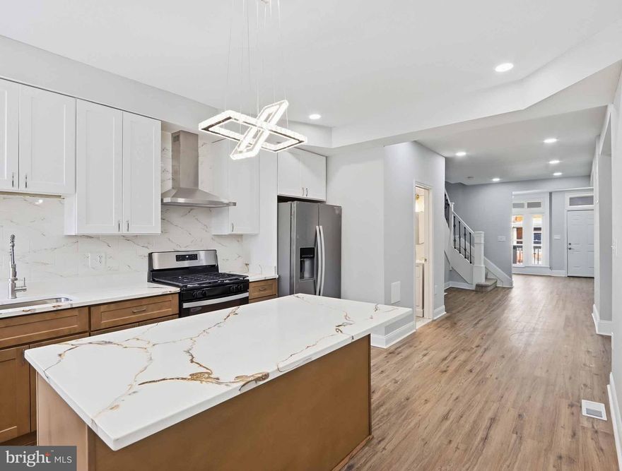 Experience comfort, character, and opportunity at 819 Belgian Ave—where affordability meets lifestyle in Baltimore’s vibrant 21218 community. Perfect place to call home why rent when you can buy, this move-in ready home blends thoughtful updates with timeless charm. Enjoy the neighborhood vibe, quick access to Johns Hopkins University, and easy commutes downtown or to I-83. With the right mix of upgrades, convenience, and value, this home is more than a property—it’s a smart investment in your future. Newly renovated home, where modern elegance meets timeless charm! A rare gem!This LARGE 3-level home has 5 freshly painted bedrooms plus 2 full bathroom  has been thoughtfully updated with newly renovated kitchen, bathrooms, flooring, heating system (2024), enjoy new finishes like quartz countertops, energy efficient stainless-steel appliances, designer tilework, and custom cabinetry. Center island with custom built in microwave, electric fireplace, and home comes equipped with Alexa features.